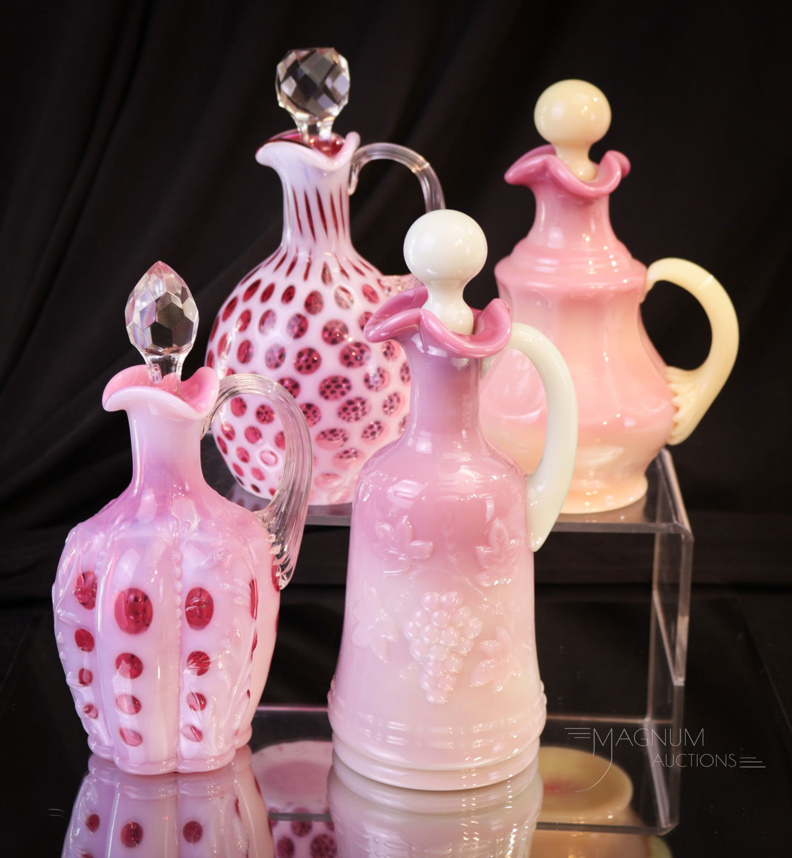 4 pc Lot Fenton Gibson Art Glass Cruets: Four select examples of art glass cruets. This lot includes two cranberry opalescent examples. One in the Honeycomb pattern. The other in the Paneled Sprig mold. These two along with a burmese and a r