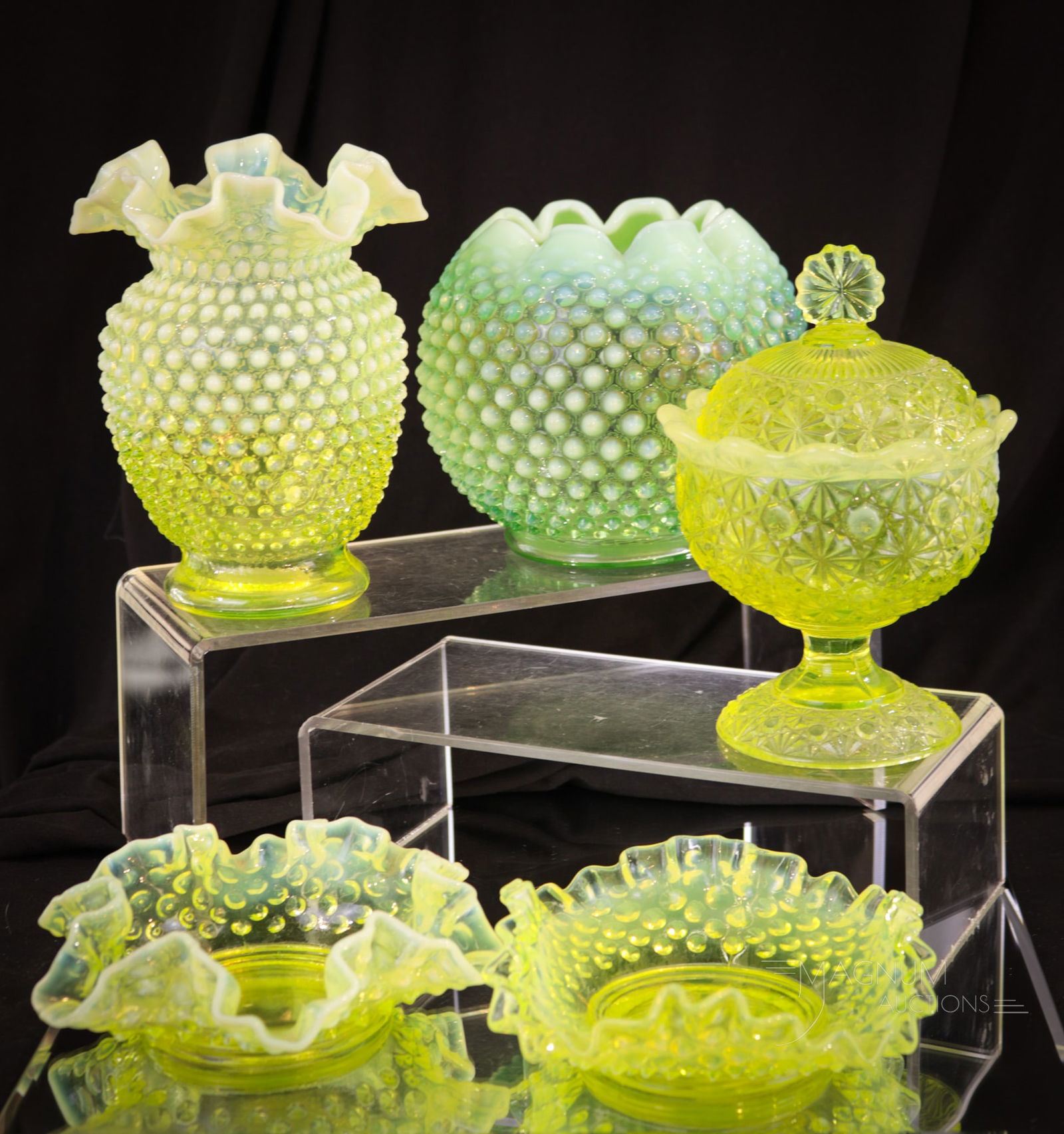 5 pc Lot Fenton Art Glass: Five selections in Fenton art glass that are sure to please. This lot includes a green opalescent Hobnail rosebowl, a topaz hobnail vase & two nappies, and a topaz opalescent Daisy and Fern covered ca