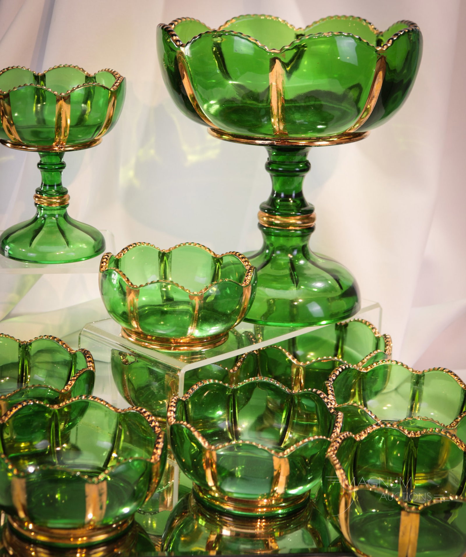 10 pc Lot Riverside X-Ray Glass: Ten superb examples of Riverside X-Ray pattern in green with gold decoration. Included in the lot is a large open compote, a jelly compote, and eight individual berry bowls. Tallest measures 8". Prove