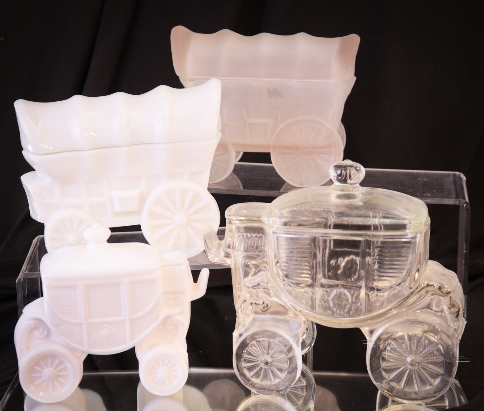 4 pc Lot Stagecoach Covered Wagon Glass Sugar Bowls: Four glass novelty finds in this offering. Two figural Stagecoach covered sugar bowls along with two Covered Wagon sugar bowls. Two examples in milk glass, one in clear, and one in clear frosted. Tall