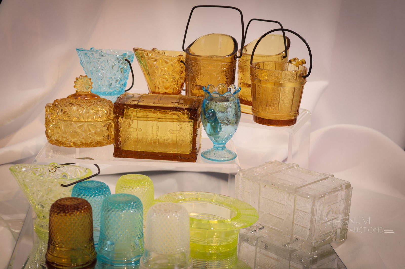 16 pc Lot Victorian Novelty Glass: Generous offering of sixteen pieces in this lot of Victorian Novelty glass. Included in this lot is a vaseline Daisy and Button Coal Hod, a Thimble shot glass, and a Derby Hat. The remainder in blue,