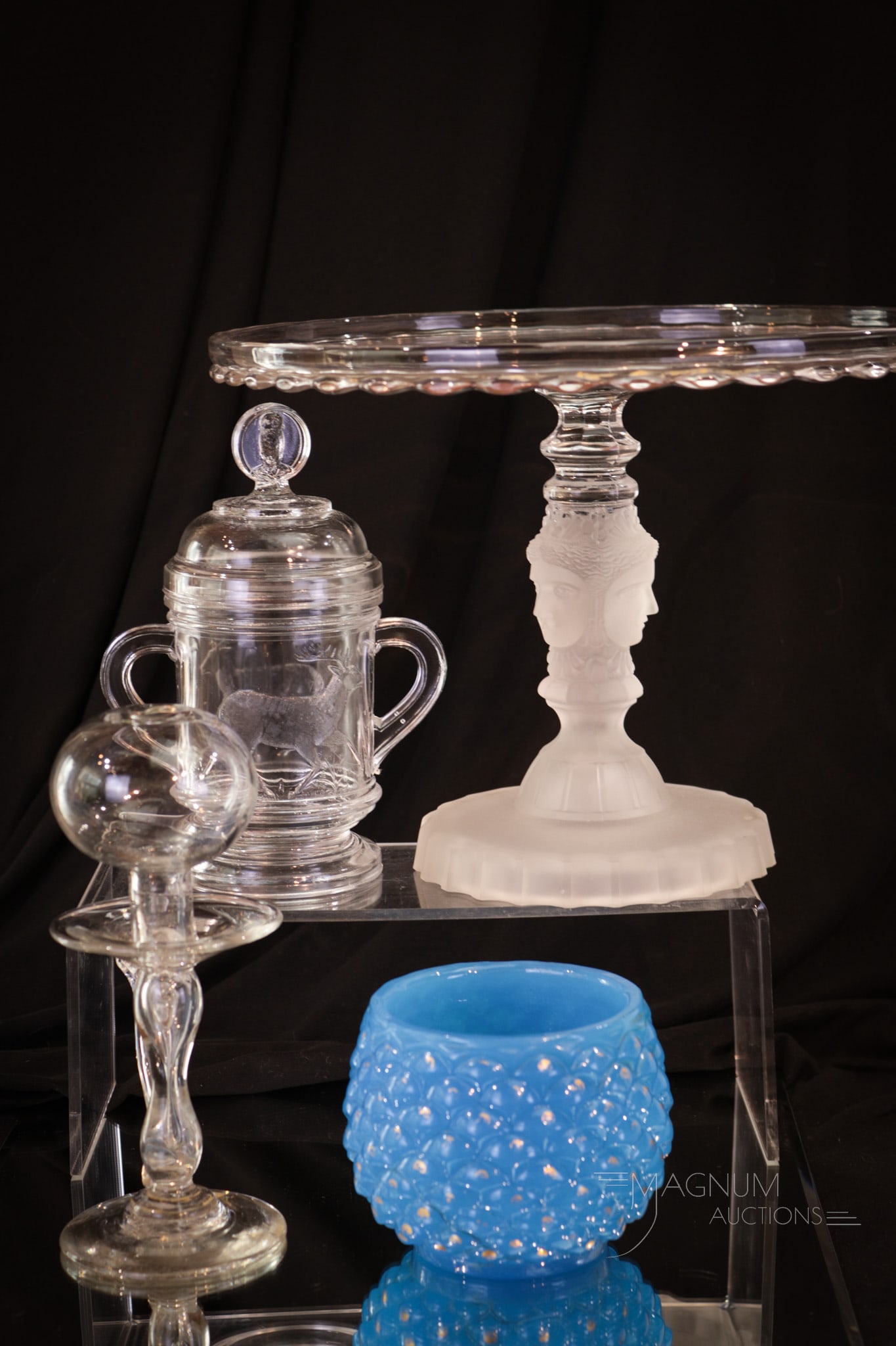 4 pc Assorted Lot Victorian Pattern Glass: Four fine and unique examples of Victorian pattern glass and more in this lot. It is comprised of a Three-Face cakestand, a Deer covered sugar bowl, a Sandwich blue opaline gilt decorated open sugar a