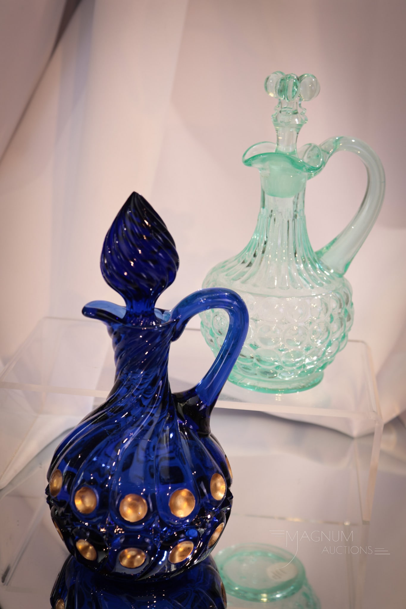 2 pc Lot Victorian Glass Cruets King's 500 & 1000 Eye: Two select Victorian glass cruets in this lot. We have a cobalt with gold decoration King's 500 pattern paired with an apple-green uranium glass 1000 Eye example. Both complete with original stoppers.