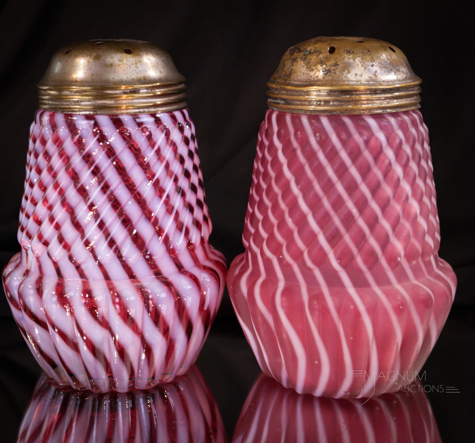 2 pc Lot Cranberry Northwood Chrysanthemum Base Swirl Victorian Sugar Shakers: Two select offerings in Northwood Chrysanthemum Base Sugar Shakers. Both in cranberry opal. One in glosssy and one in rich satin finish. Each measures 4 1/2" tall.