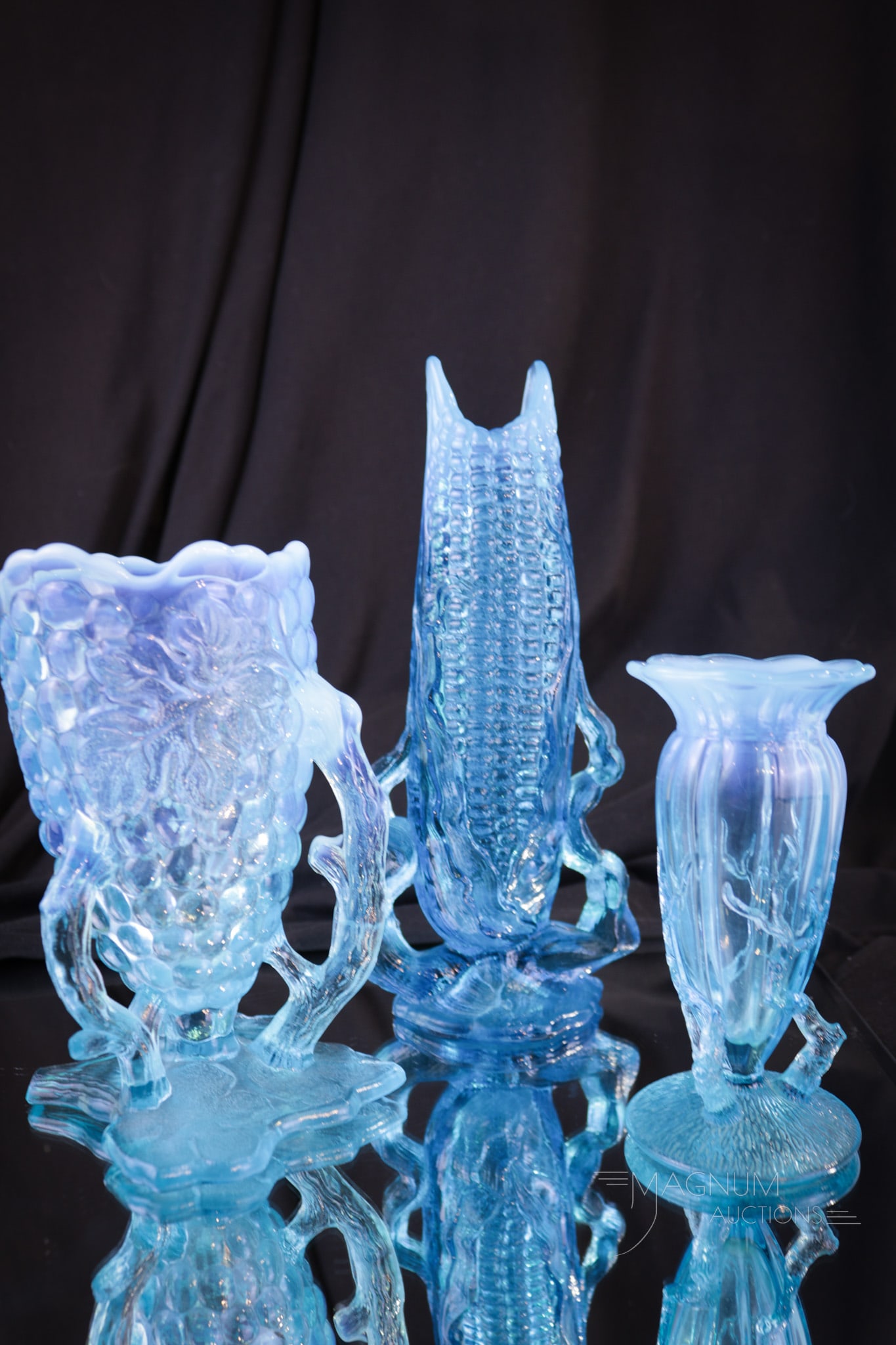 3 pc Lot Blue Opalescent Glass Whimsy Vases: Three fine examples of blue opalescent Victorian whimsy vases. One in Tiny Twigs pattern, one in Grape Cluster, and one in Corn pattern. Tallest measures 7 3/4" tall.