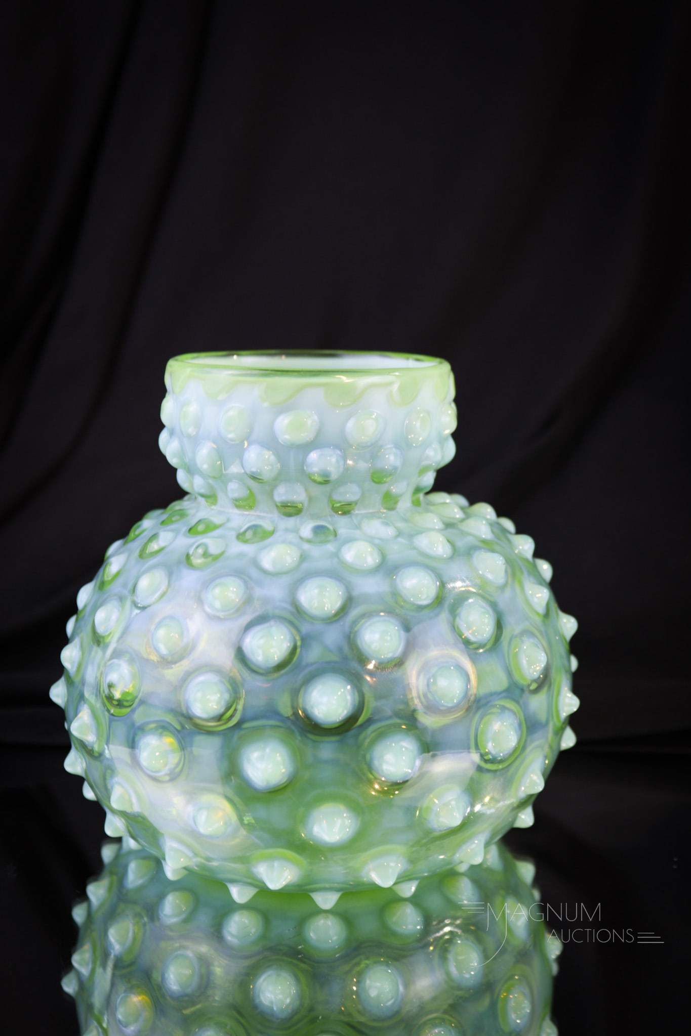 Green Opalescent Hobanil Spittoon Vase: A beautiful green opalescent hobnail glass spitton shape squat vase. This one with eye-pleasing bulbous dumpy form. Vase measures a whopping 4 1/2" tall. A wonderful piece but then again, one you hard