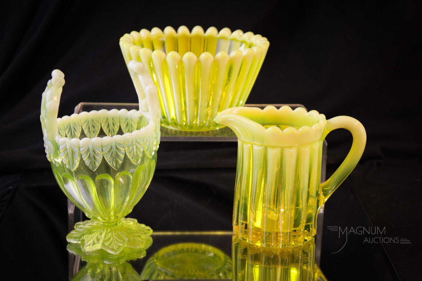 3 pc Lot English Vaseline Opalescent Victorian Glass: Three selections sure to be collection enhancing in vaseline glass. This lot is comprised of a Helen Louise creamer and sugar along with a Twigs and Leaves pattern basket. Tallest measures 5 1/2".