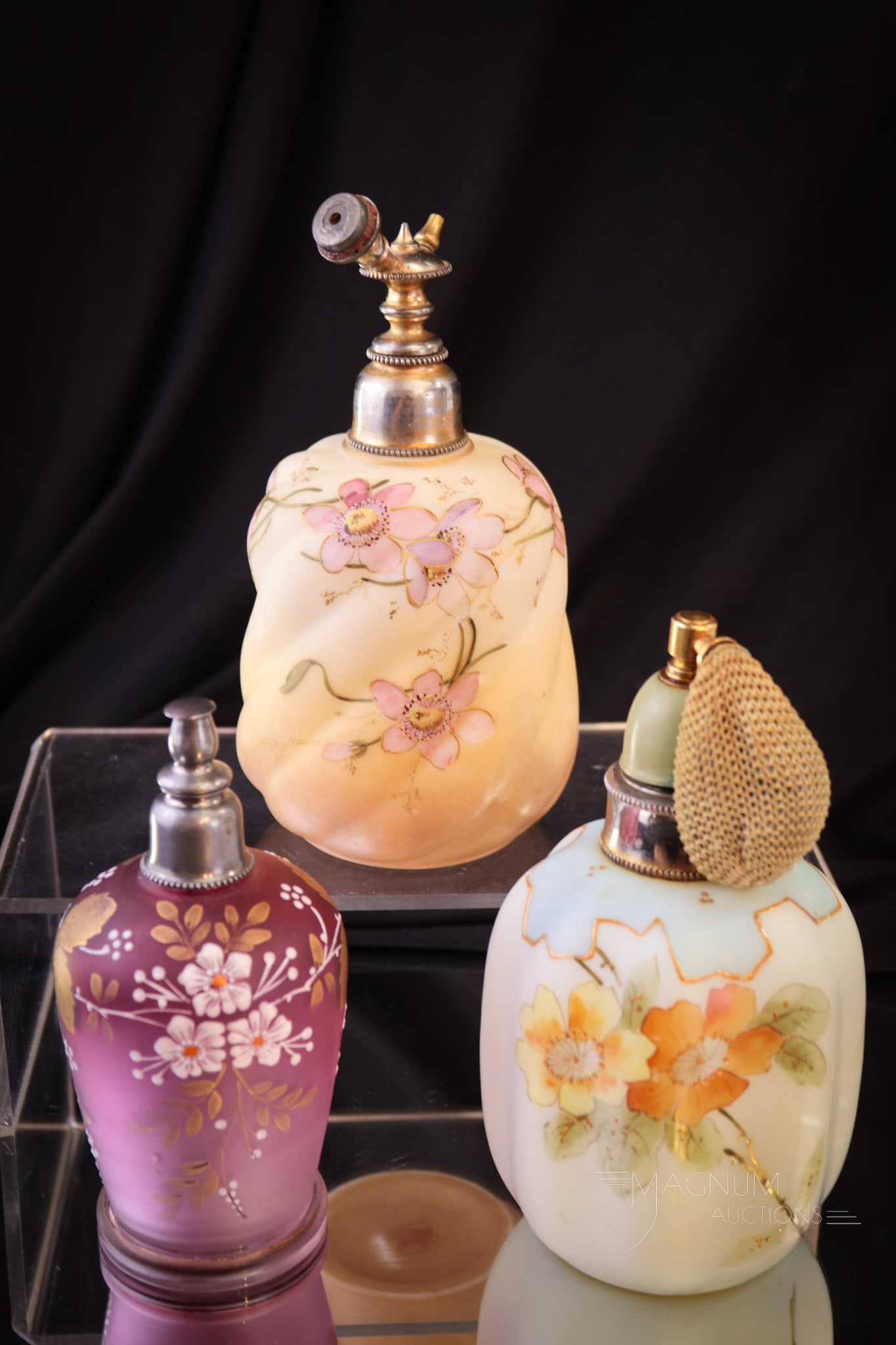 3 pc Lot Victorian Satin Enameled Glass Perfume Atomizers: Three fine examples of Victorian satin glass perfume atomizers. Each of these unique pieces is expertly decorated and features original mountings. Two in lusterless satin glass and one in satin cranbe