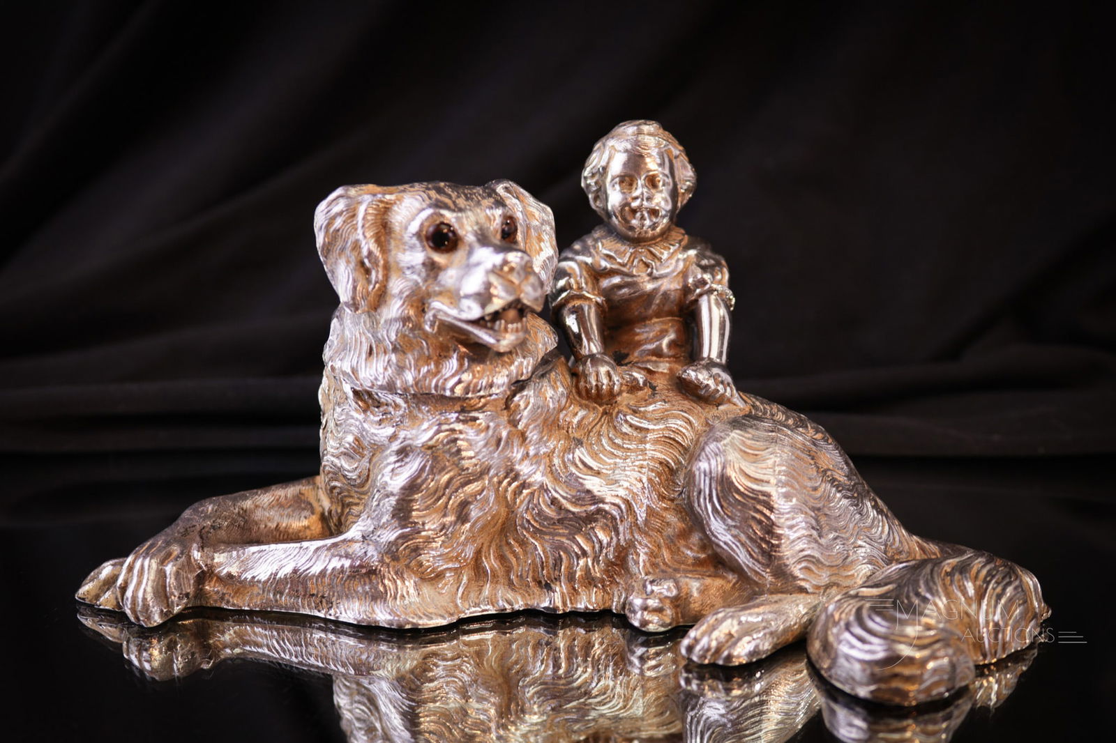 Meriden Silverplate Figural "Girl with Dog" Inkwell: A charming piece to say the least. This inkwell is signed Meriden silverplate. It is in the form of a Victorian young girl and her dog. Piece measures 3" tall. Provenance: This item is from the priva
