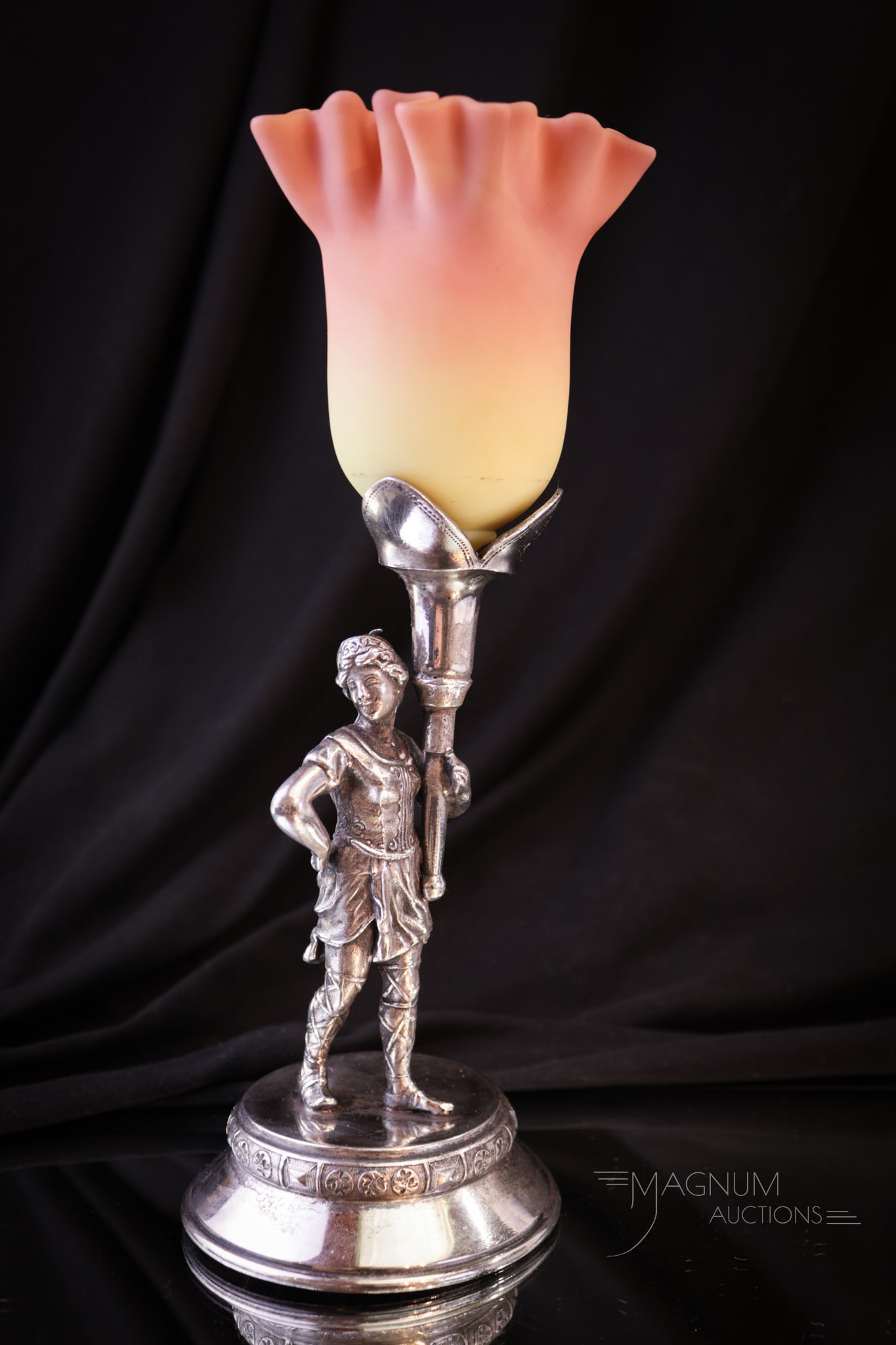 Meriden Silver Plate Victorian Webb Burmese Glass Figural Vase: A signed Meriden Victorian silverplate figural holder of a woman warrior complete with Webb burmese glass posey vase in the top. Complete measures 8 1/2" tall. Provenance: This item is from the privat