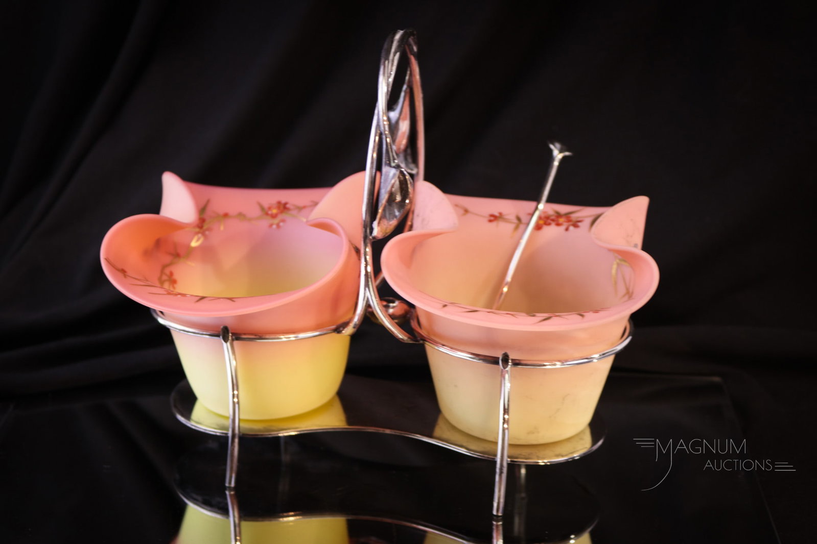 Webb Burmese Decorated Victorian Double Sweetmeat & Silver Plate: A fine offering of a marked English silverplate double sweetmeat frame complete with enameled and gilt decorated Webb burmese glass inserts. Each with florals and butterflies. Piece measures 6 1/2" ta