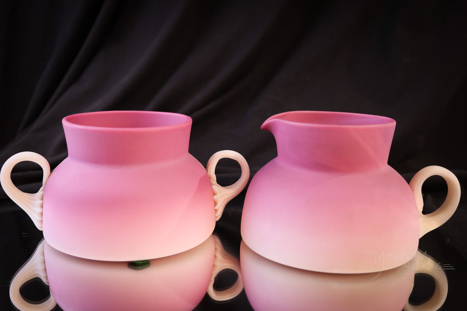 New England Peachblow Satin Victorian Glass Creamer & Sugar: Two pieces of New England Victorian glass in peachblow with satin finish. Here we have a creamer along with a sugar bowl. Tallest measures 2 1/2". Provenance: This item is from the private collection 