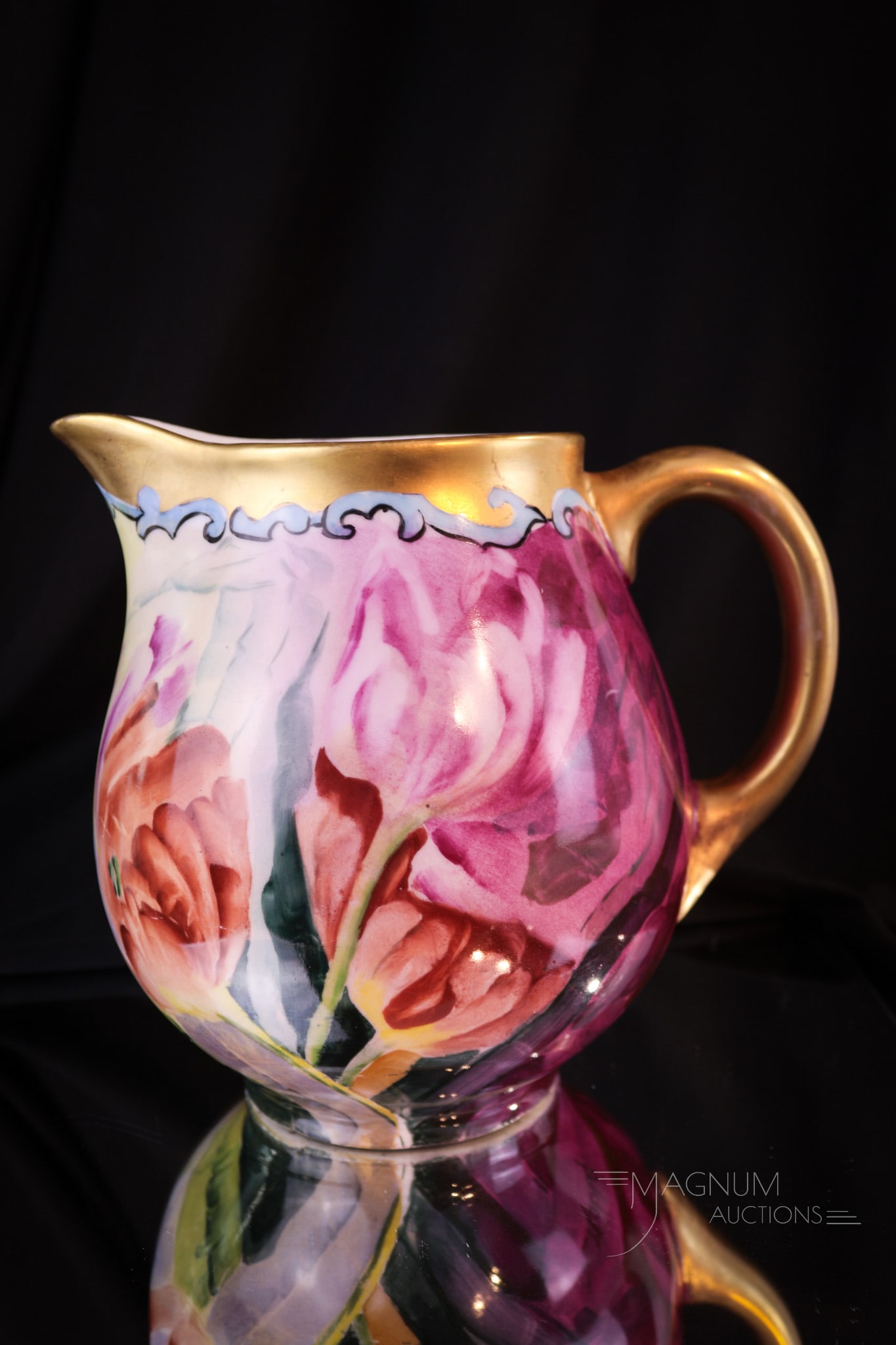 W.G. Limoges France Hand Painted Porcelain Pitcher: Vivid colors adorn this beautiful marked W.G. Limoges pitcher with tulips. This example has lots of gilt decoration as well. Piece measures 7" tall.
