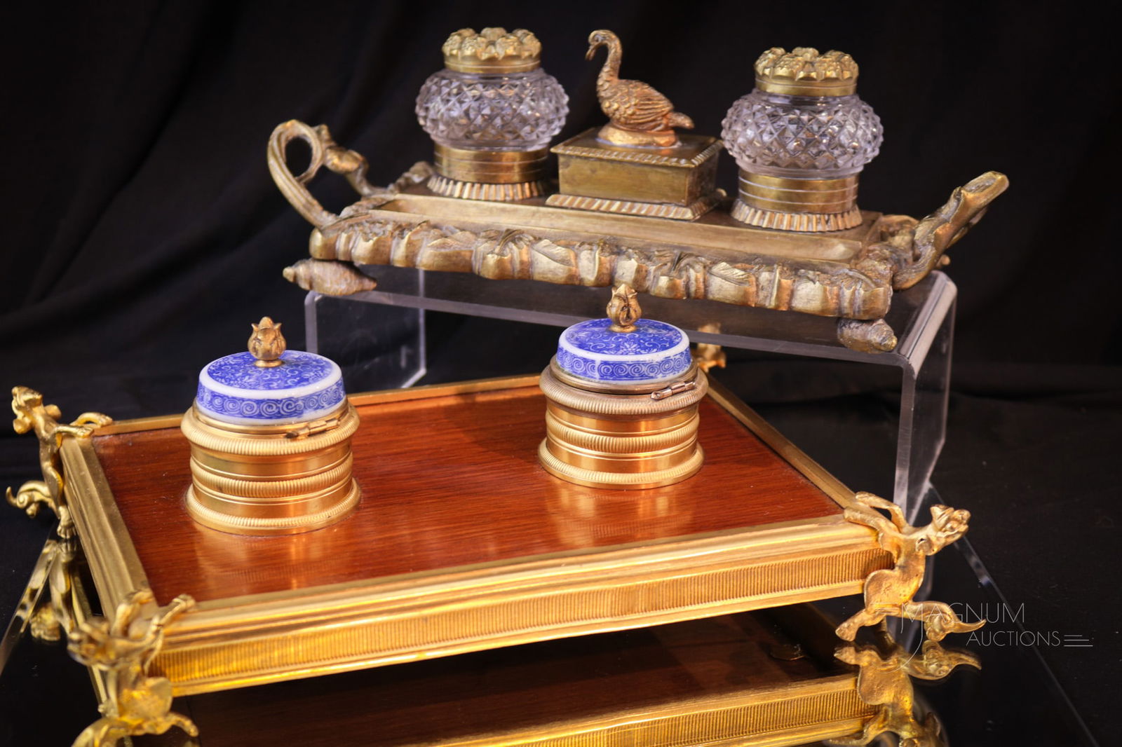 2 Double Antique Inkwell Sets Mahogany Regency Bronze: Two delights in antique double inkwells. The first a mahogany and bronze in Regency style with figural feet and blue and white porcelain. The second is a brass complete with cut glass wells and a duck