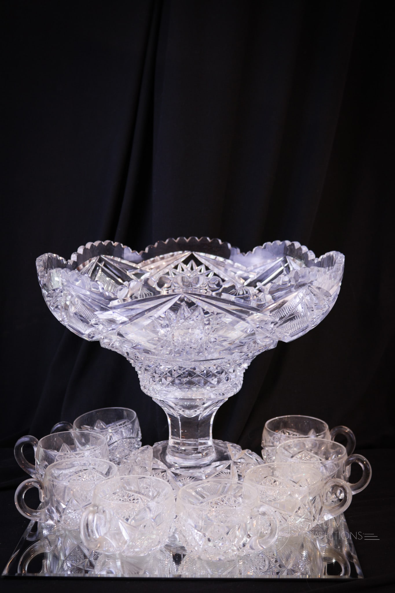 10 pc American Brilliant Cut Glass Pedestal Punch Bowl & Cups: Select ten piece American brilliant cut glass punch set. This set is complete with eight cups, punch bowl and stand. Complete the tallest measures 9 3/4" tall, 11 1/2" wide. One chip to a single tooth