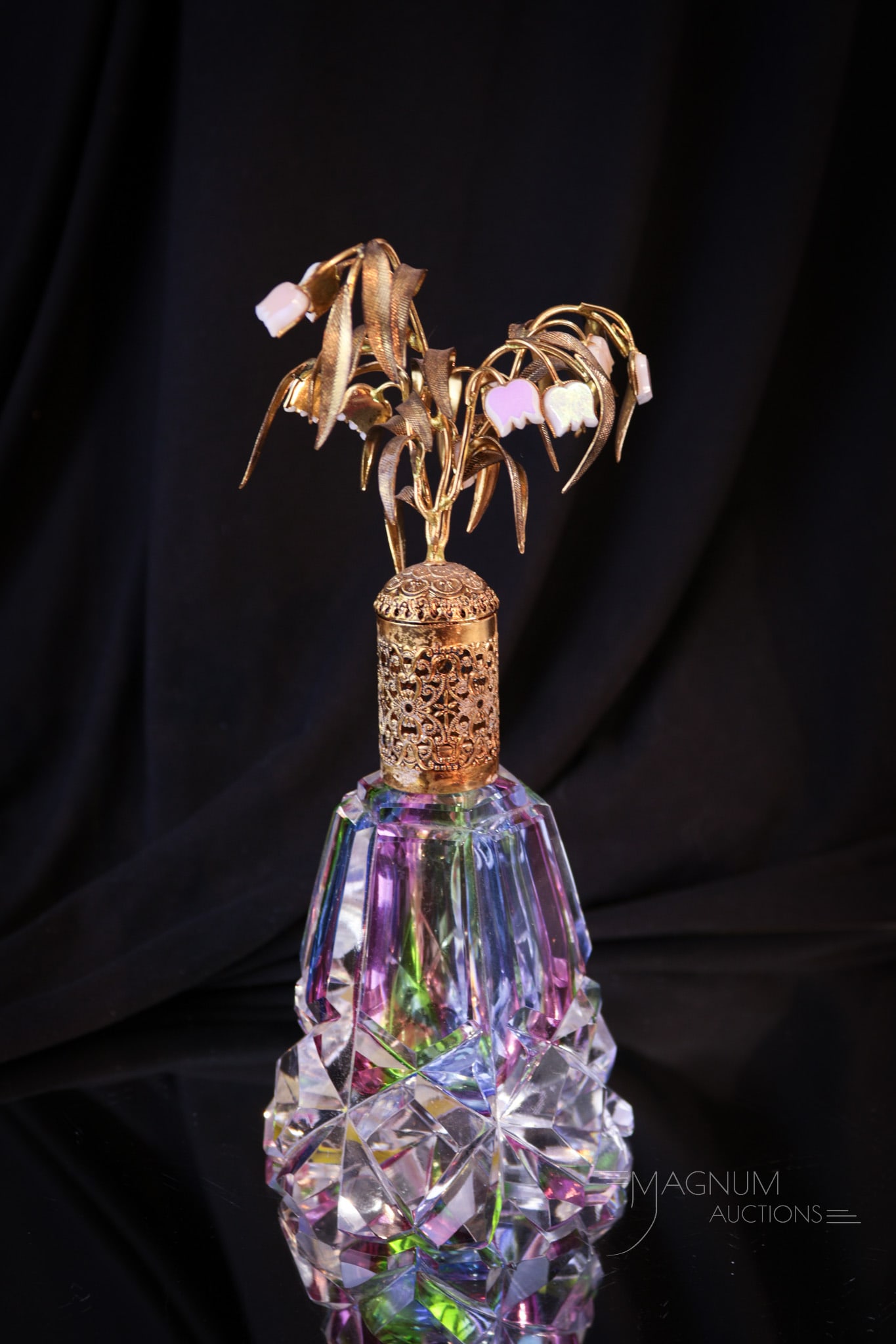 Irice West Germany Rainbow Cut Glass Perfume Bottle: Beautiful mid century Irice West Germany rainbow cut glass perfume bottle with floral top fittings in brass and mother of pearl. Bottle measures 7 1/2".