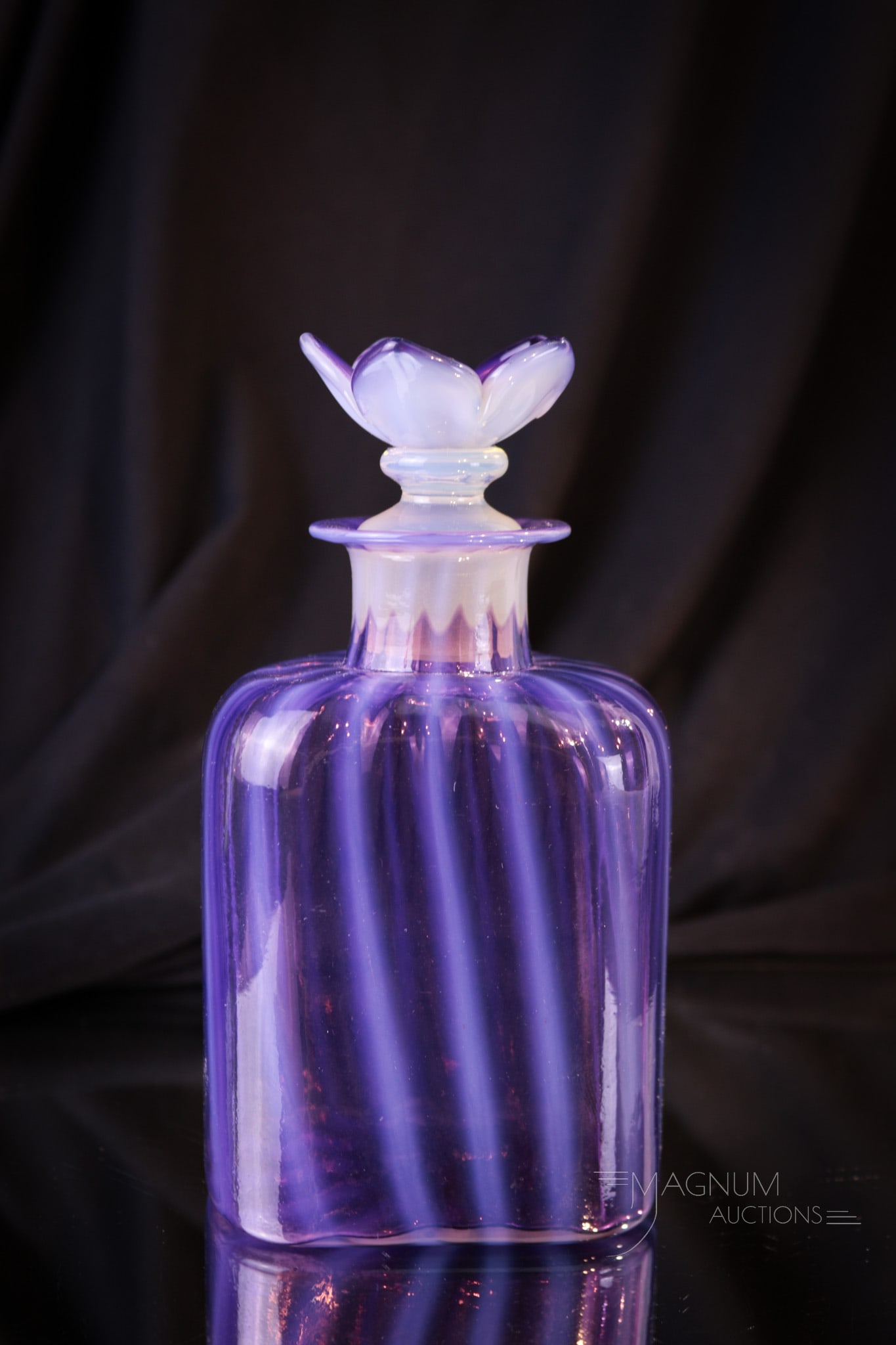Steuben Oriental Orchid Flower Stopper Toilet Bottle: Gorgeous Steuben Oriental Orchid toilet bottle complete with floral matching stopper. Fine color and a perfect example. Bottle measures 5 1/2" tall to the top of the stopper.