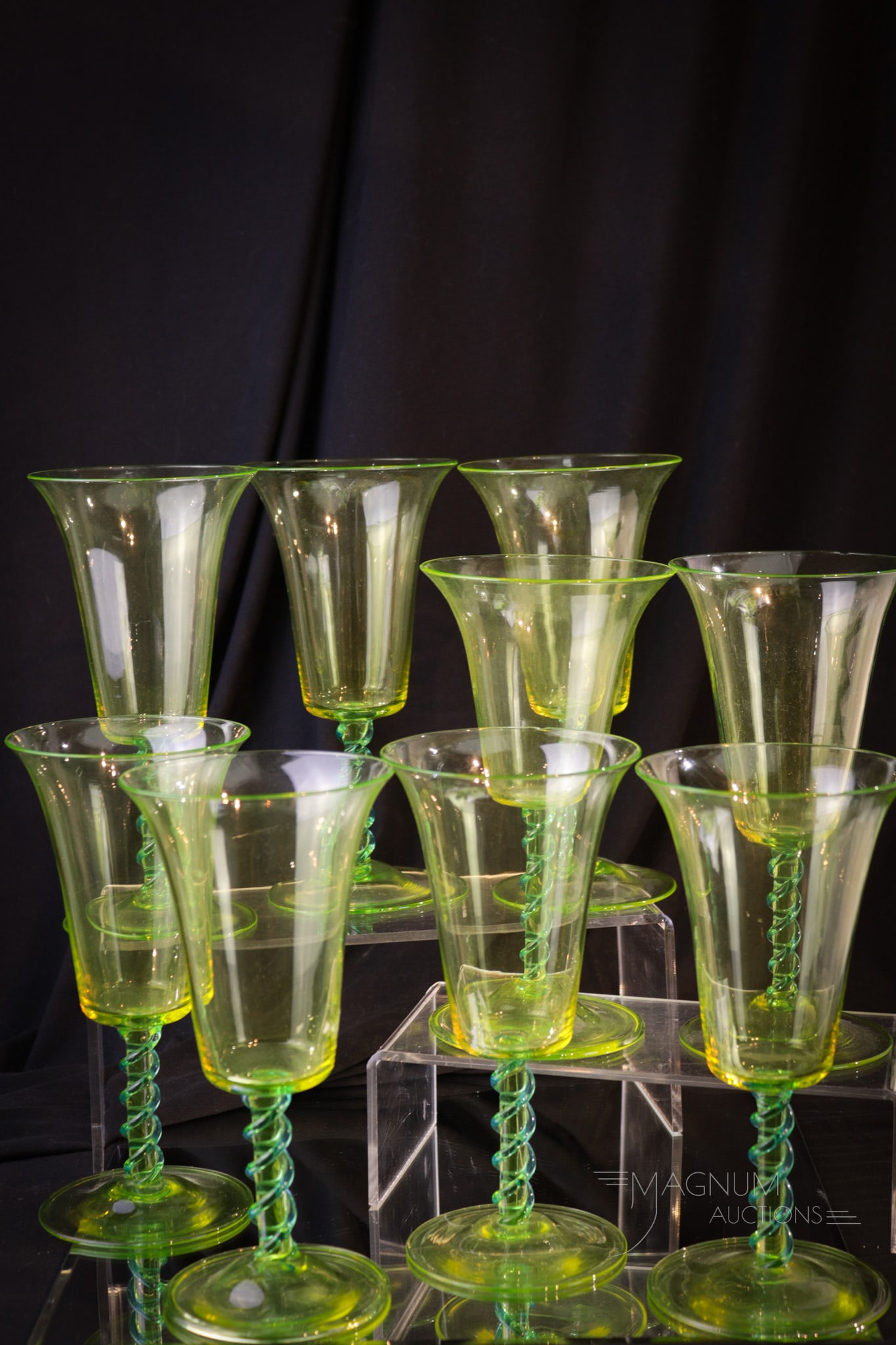 9 pc Steuben Topaz Vaseline Celeste Blue water Goblets: Nine lovely finds in Steuben Topaz (vaseline) with Celeste blue applied twistes to the stems. Each measures 7 1/2" tall. All are signed. Three stems have minor sliver rim chips as shown.