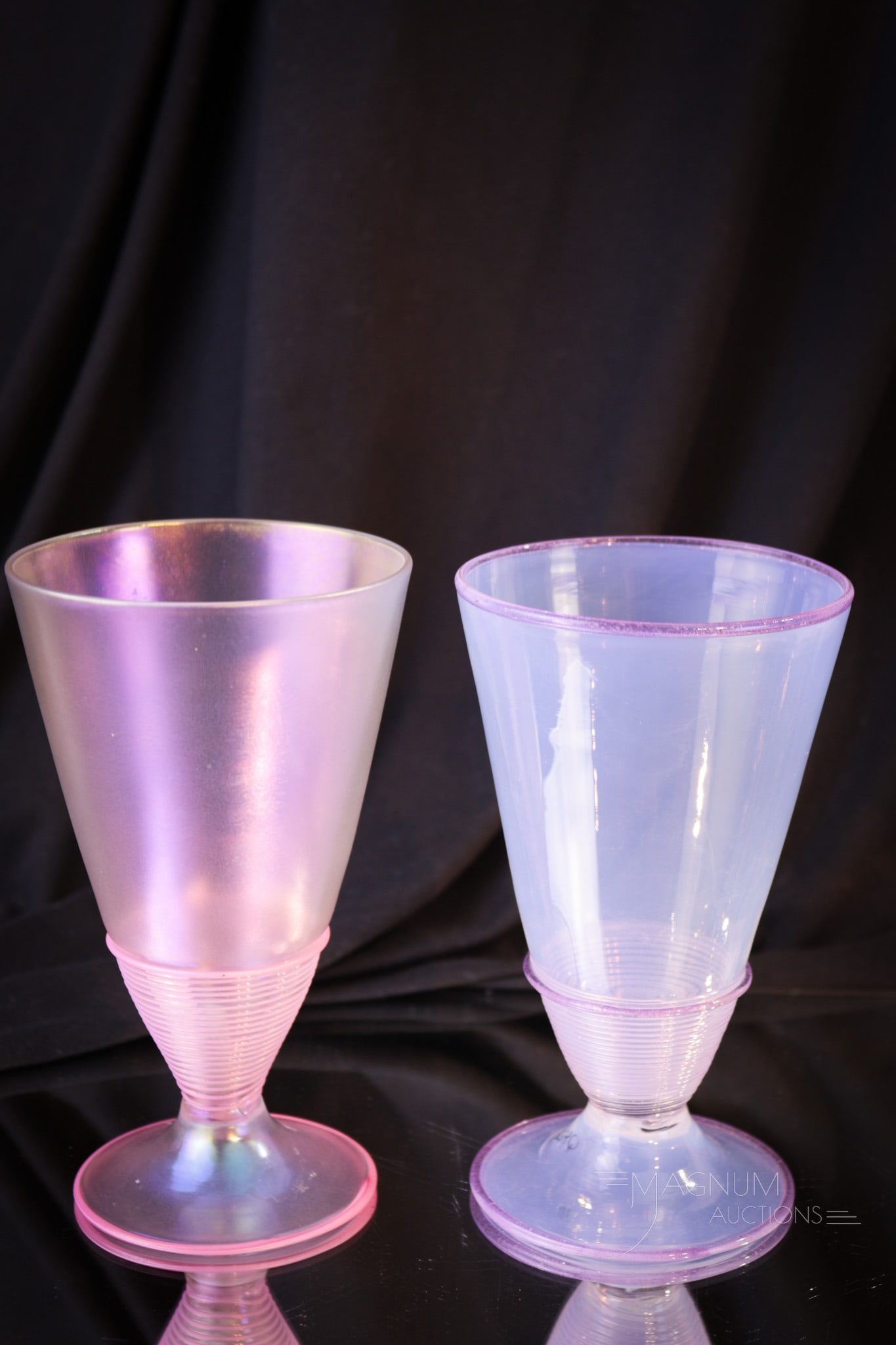 2 pc Lot Steuben Threaded Art Glass Goblets: Two unique Steuben threaded art glass goblets in this offering. The first is a Verre De Soie with applied pink threading. The second is a purple opal example with purple threading. Tallest measures 6"