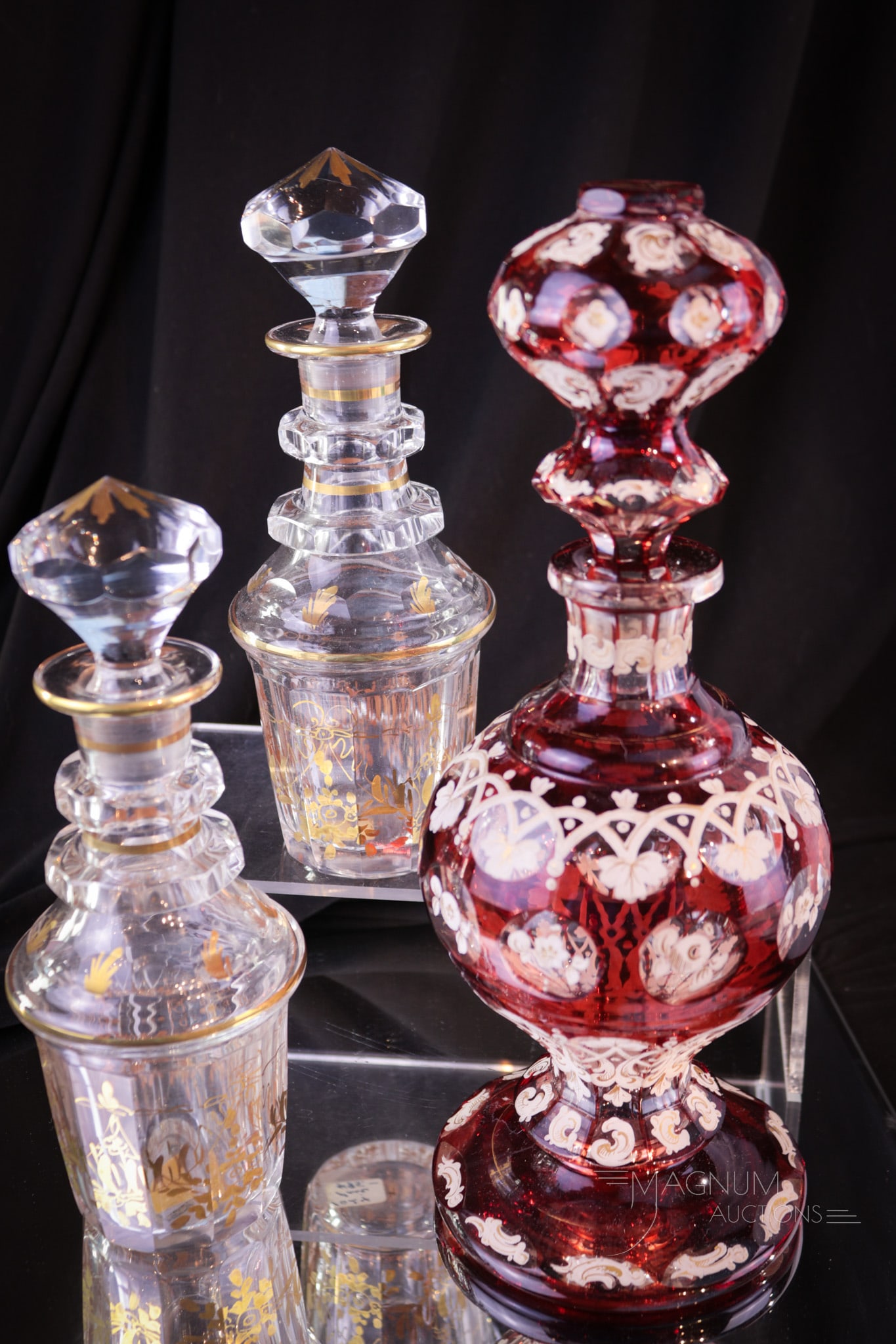 3 pc Lot Bohemain Glass Cologne Decanters Pair & More: A super offering of three Bohemian glass bottles each complete with original stoppers. Two are a matched pair. One is unique with ruby flashed cut-to-clear body and stopper.All three are lovely exampl
