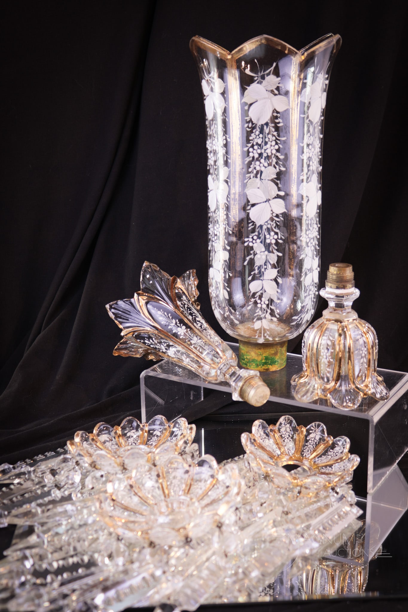 Baccarat French Art Glass Lusters Parts Lot: This lot is made up of hard-to-find parts of Baccarat lusters. This lot includes 3 bobeches complete with prisms, a single candle cup, a chimney shade, and one vase. Largest measures 10 1/2".