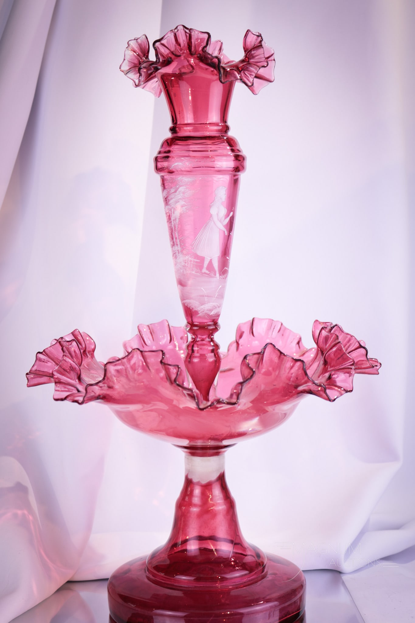 Rare Cranberry Victorian Mary Gregory Epergne Centerpiece: Fine and rarely found cranberry Mary Gregory decorated epergne centerpiece. This is lovely with deep rich cranberry color and crisp white enameled decoration. Piece measures 19" tall, 11 1/2" wide.