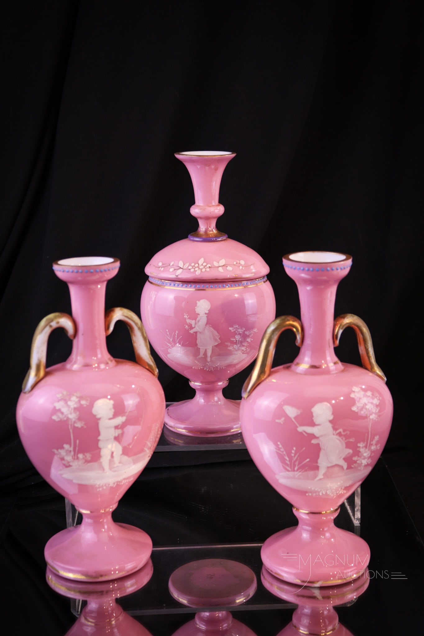 3 pc Pink Cased Victorian Vanity Perfume Cologne Castor Set: Three fine pieces make up this Victorian pink cased enameled glass vanity set. This set decorated with florals and plenty of gilt trim. Tallest of the set measures 8".