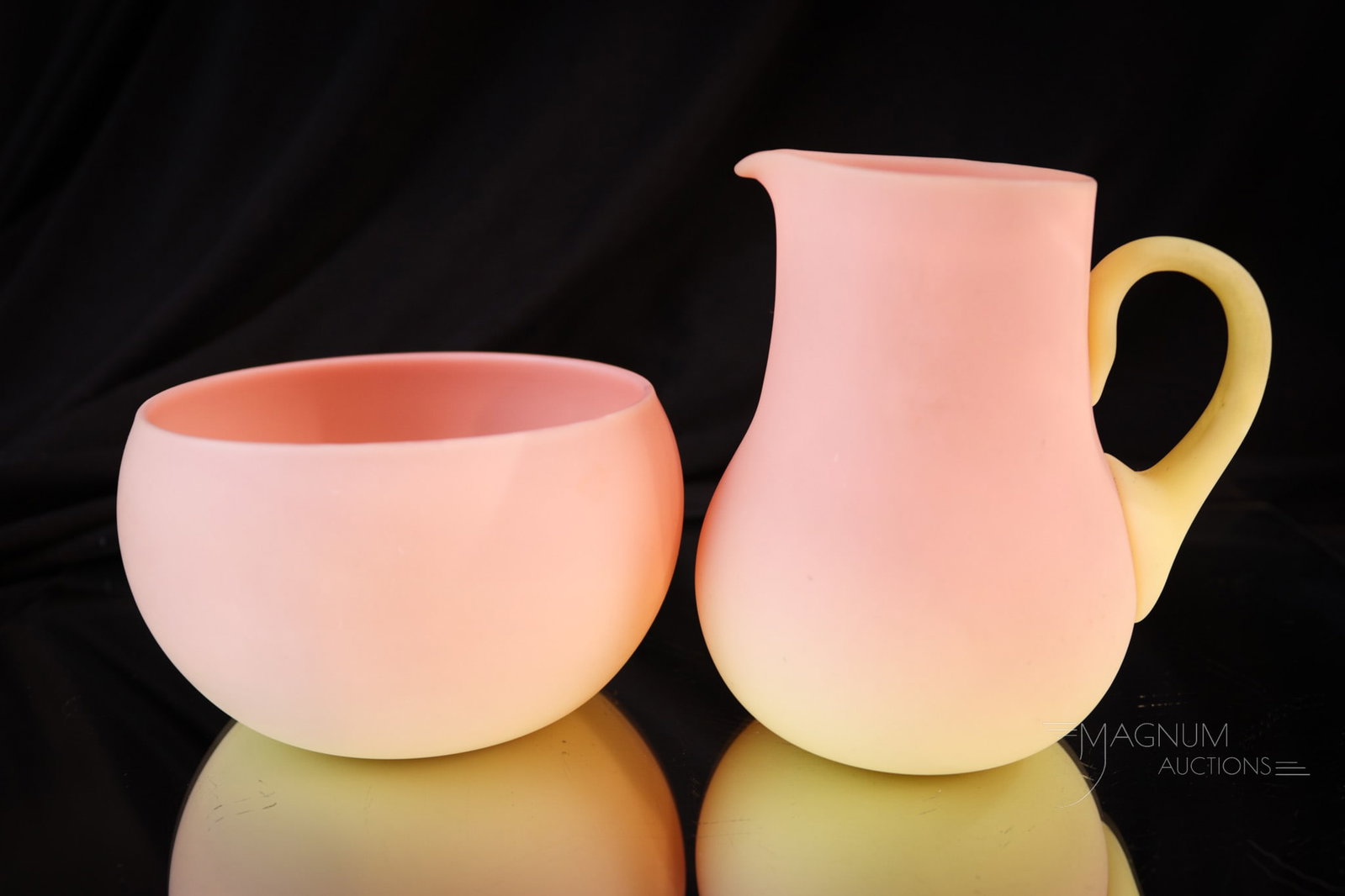 Mt. Washington Burmese Victorian Glass Creamer & Sugar: Lovely pairing of two pieces of Mt. Washington burmese glass. This is a creamer along with an open sugar. Creamer with applied handle. Tallest of the pair measures 3 3/4". Provenance: This item is fro