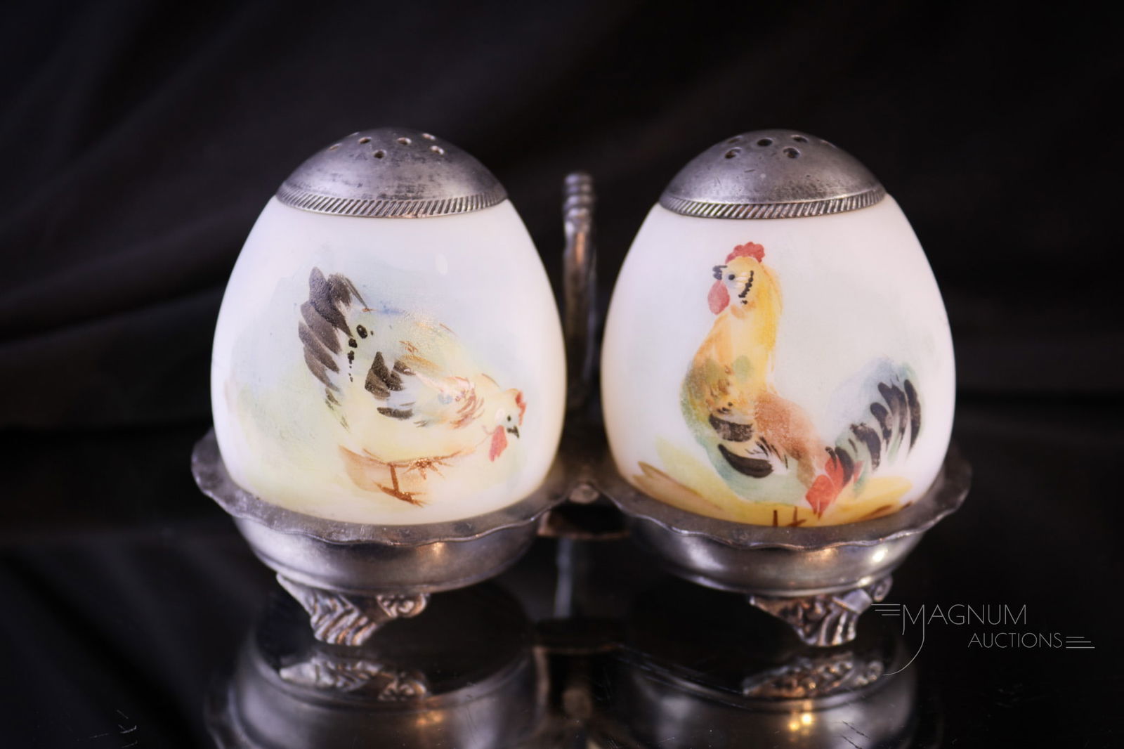 Pairpoint Silver Plate Chicken & Rooster Mt. Washington Shakers: Select offering of a signed Pairpoint silver plate holder complete with a pair of chicken and rooster decorated egg Mt. Washington salt shakers. Complete this lovely offering measures 2 3/4" tall. Pro