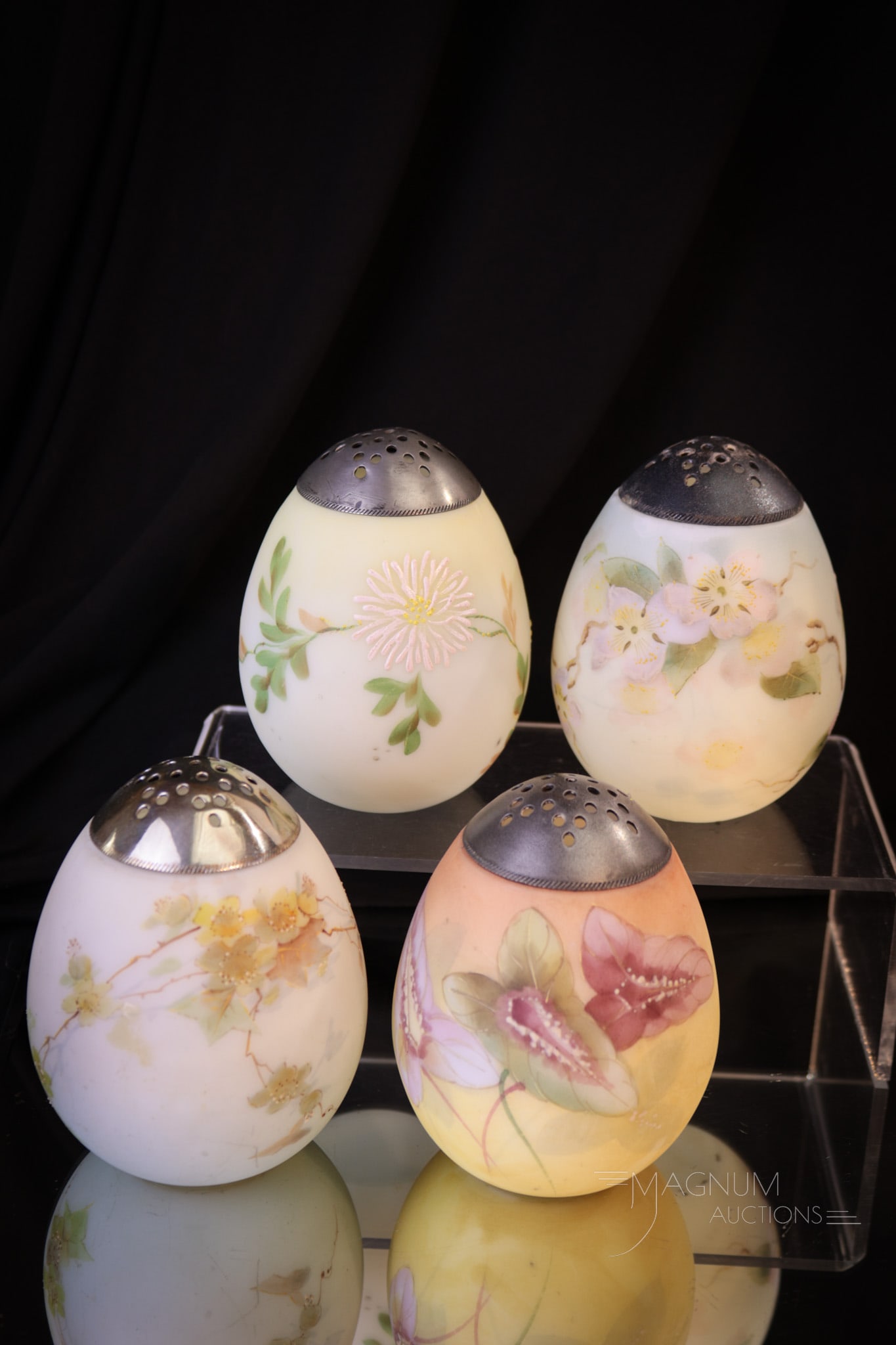 4 pc Lot Mt. Washington Victorian Glass Egg Sugar Shakers: Four selections in Mt. Washington glass egg sugar shakers that are sure to be collection enhancing. Each with a unique floral décor. Each measures 4 1/4" tall.
