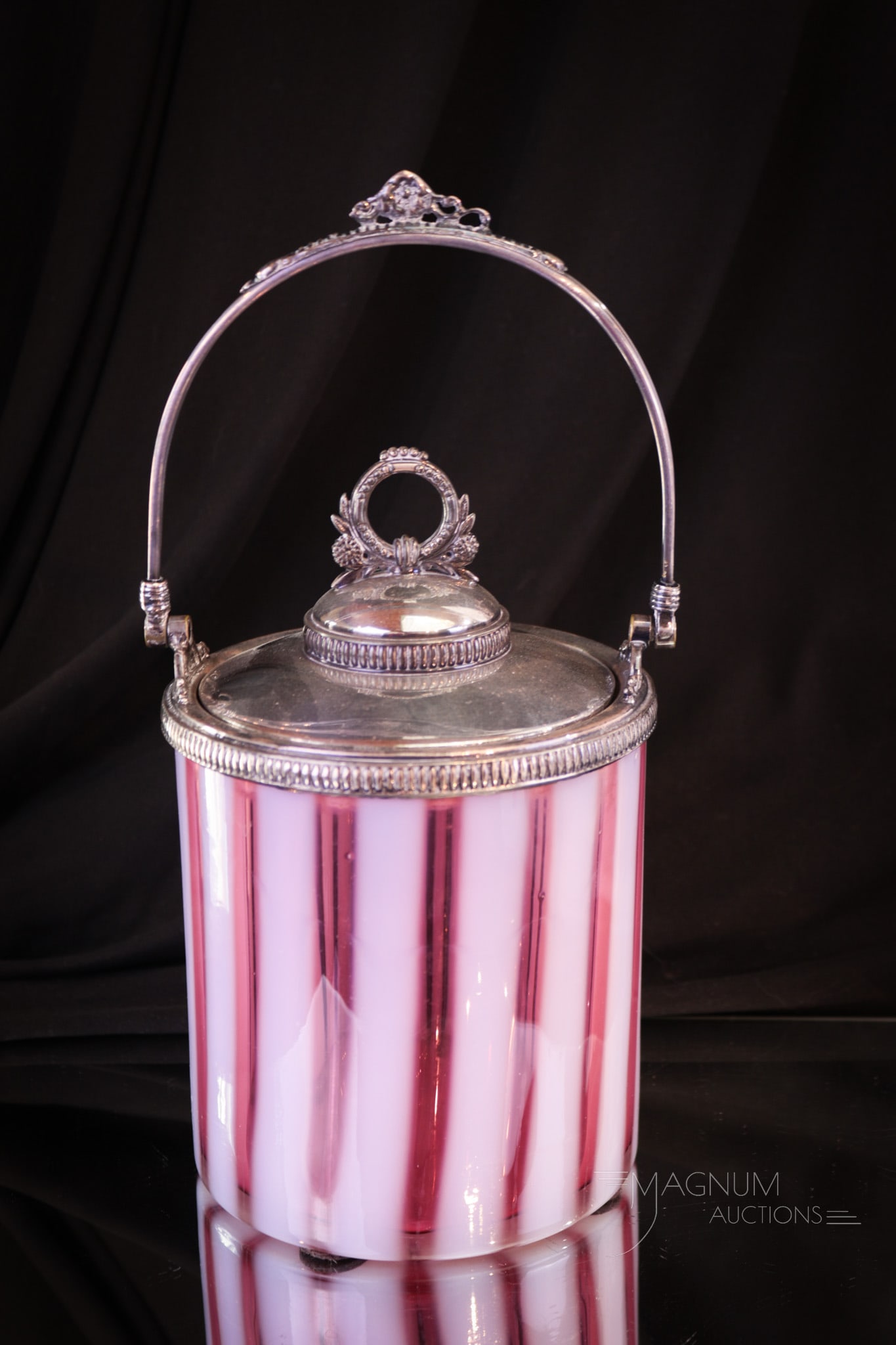 Rare Cranberry Opalescent Victorian Stripe Biscuit Jar: Killer example of a rarely seen Victorian biscuit jar. This one in the Stripe pattern. Perfect color and opal and original mountings make up this offering. Piece measures 8" tall.