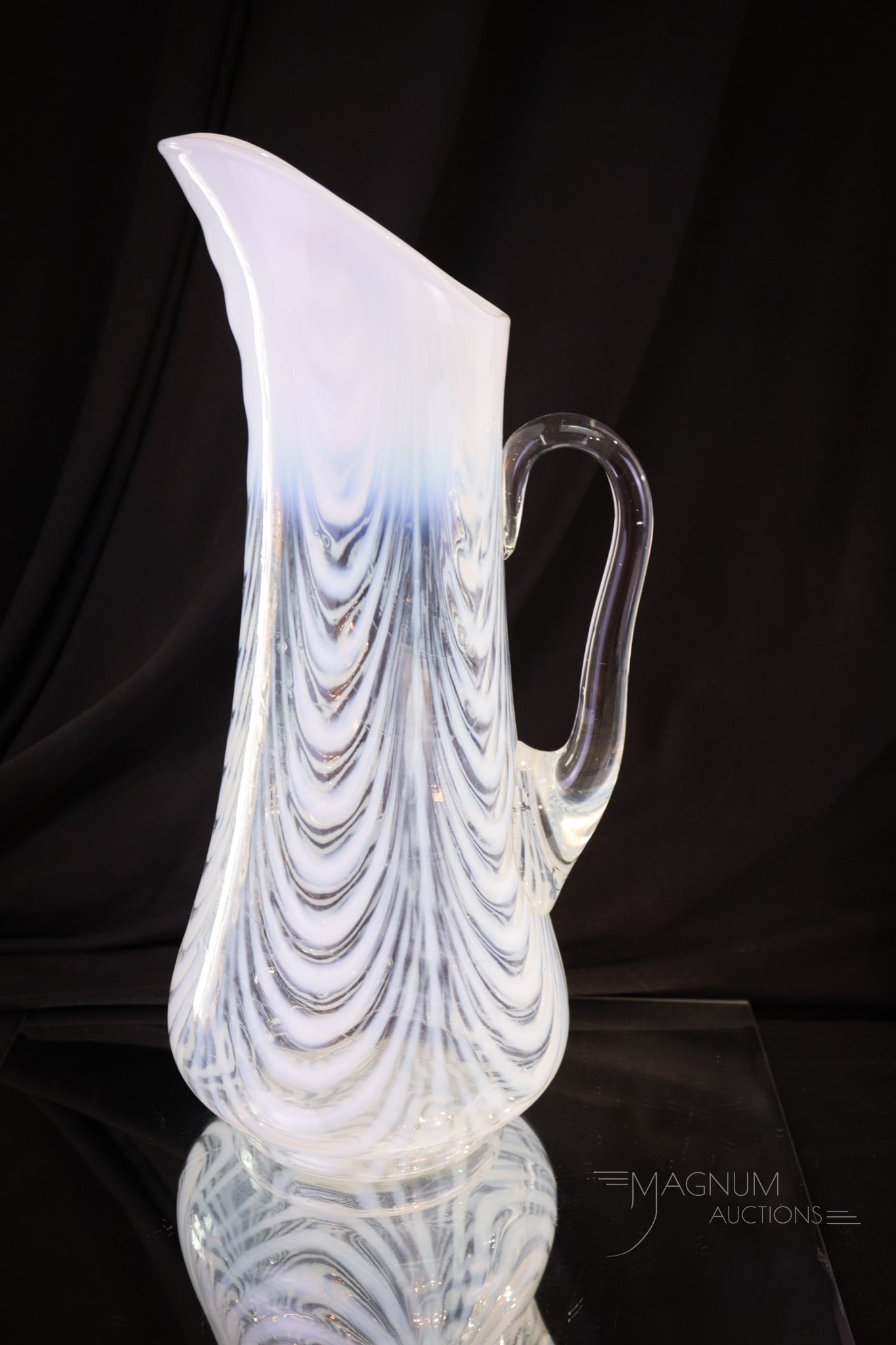 Northwood Opalescent Blown Drapery Tankard Pitcher: A superb example of a Northwood opalescent Drape pattern tankard pitcher. Take note of the gorgeous heavy opal and crystal clear glass. This one is a must-have example. Pitcher measures 13 1/4" tall.