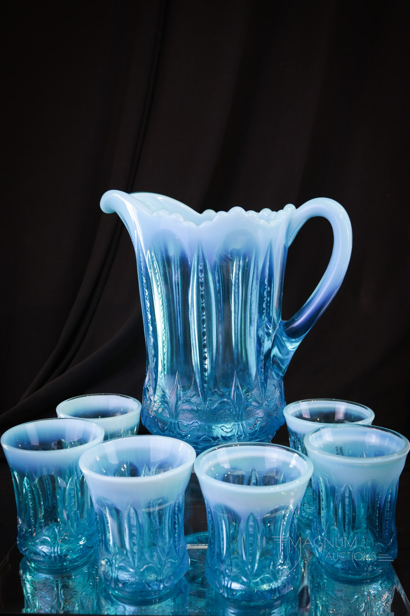 7 pc Set Jeffrerson Blue Opalescent Iris with Meander Victorian Glass Water Set: Brilliant blue color is found on this fine seven-piece water set in the Jefferson glass Iris with Meander pattern. Make way on the curio shelf for this lovely offering. Tallest measures 8 3/4".