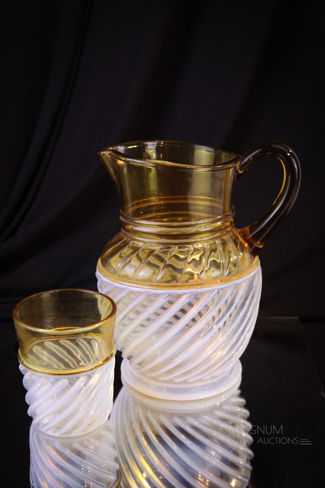 2 pc Lot Amber Opalescent Gonterman Adonis Victorian Pitcher & Tumbler: Two select pieces in amber opalescent Gonterman Swirl in this lot. A pitcher with matching tumbler. Each a strong example. Tallest measures 8".