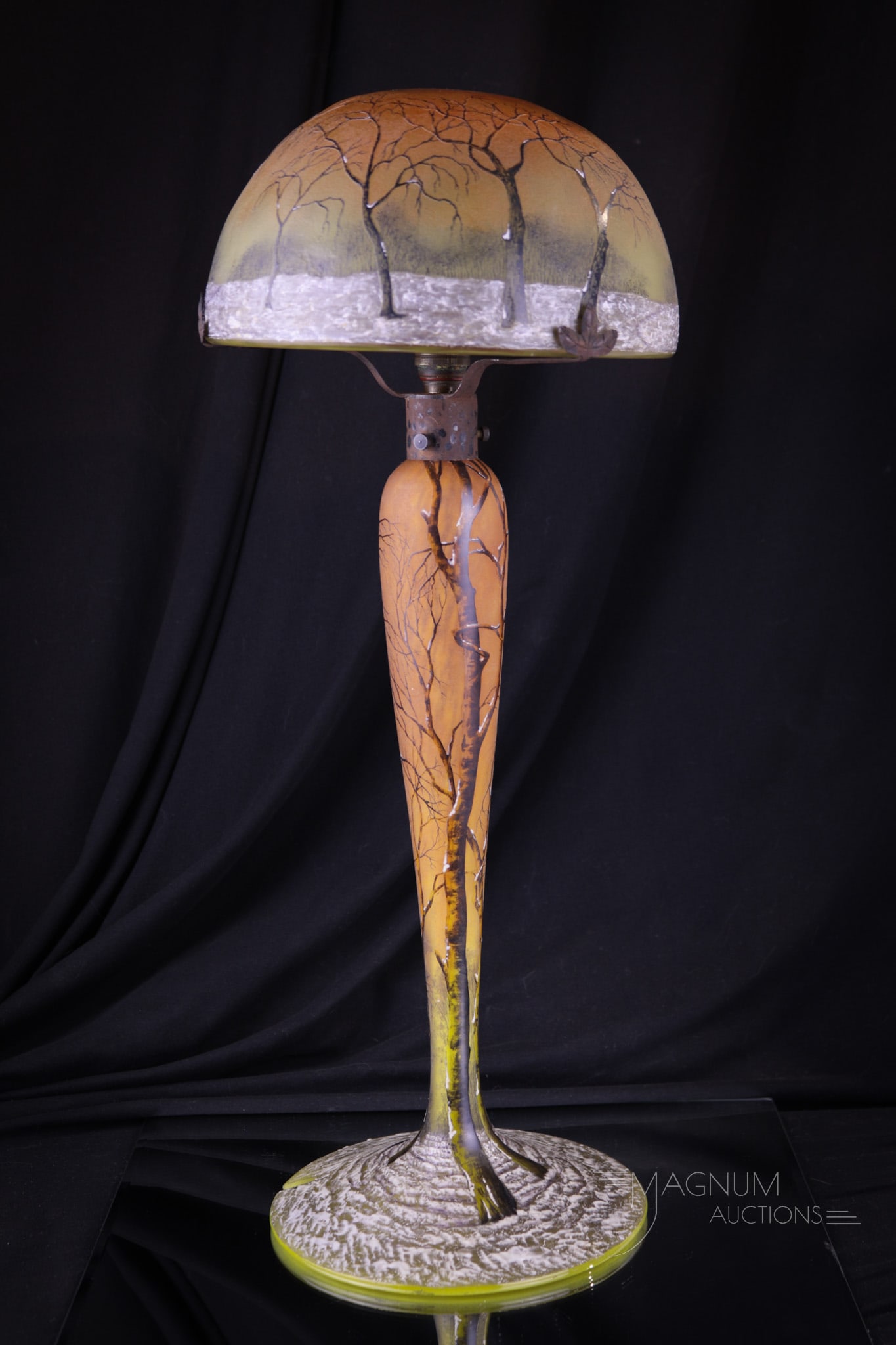 Signed Daum Nancy Winter Scene 18" Table Lamp: A fantastic example of signed Daum Nancy in this 18" tall winter scene enameled and cameo glass table lamp. Brilliant colors and superb detail to this amazing lamp. Lamp measures 18" tall. Lamp requir