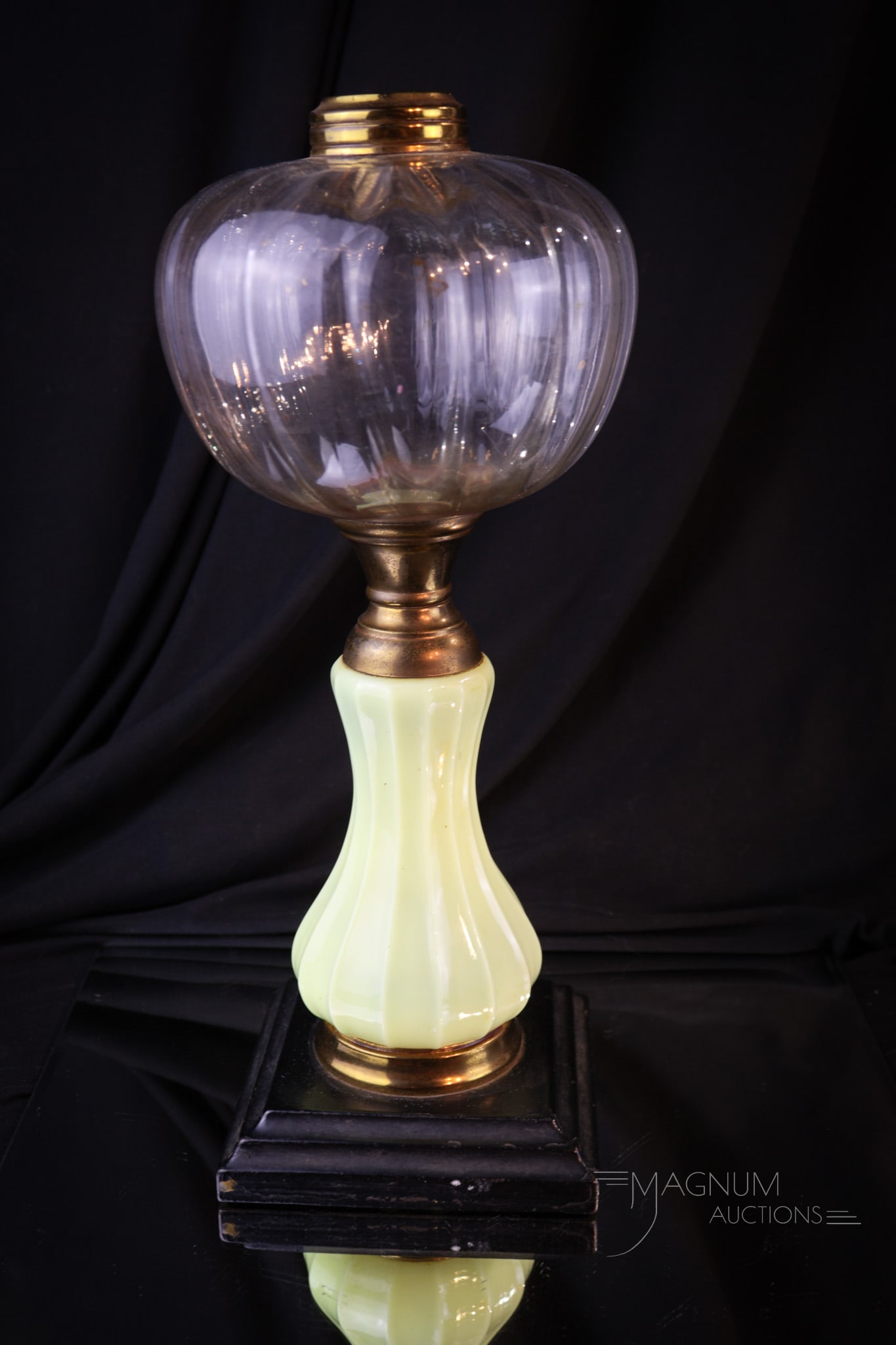 Uranium Custard Stem Victorian Oil Lamp: A seldom found Victorian uranium custard glass Victorian oil lamp with clear font and metal base. This beautiful offering lights up under black light. It's a shiner folks! Lamp measures 12 1/2" tall.