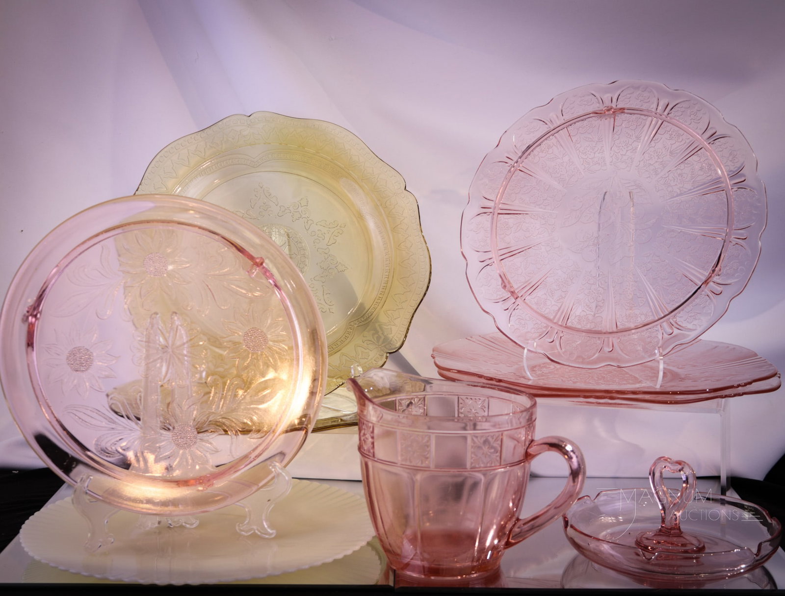 9 pc Lot Depression Glass: Select offering of antique depression era glass. Included in the lot is patterns such as Doric,Dogwood, American Sweetheart, Cherry Blossom, Madrid, and Monax. Largest measures 5" tall.