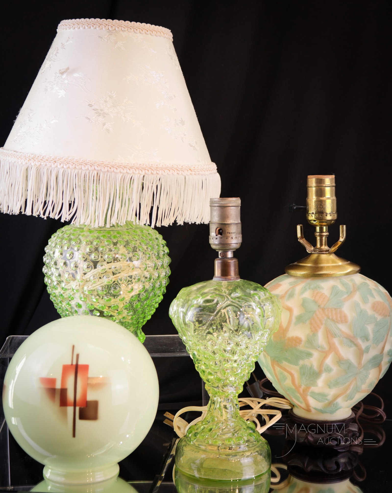 4 pc Lot Uranium "Vaseline Spendor in Lighting": Four select finds in uranium vaseline glass. Featured is a vaseline Hobnail pattern lamp complete with fabric shade, A vaseline green grape cluster form lamp base, a Consolidated glass lamp base and c