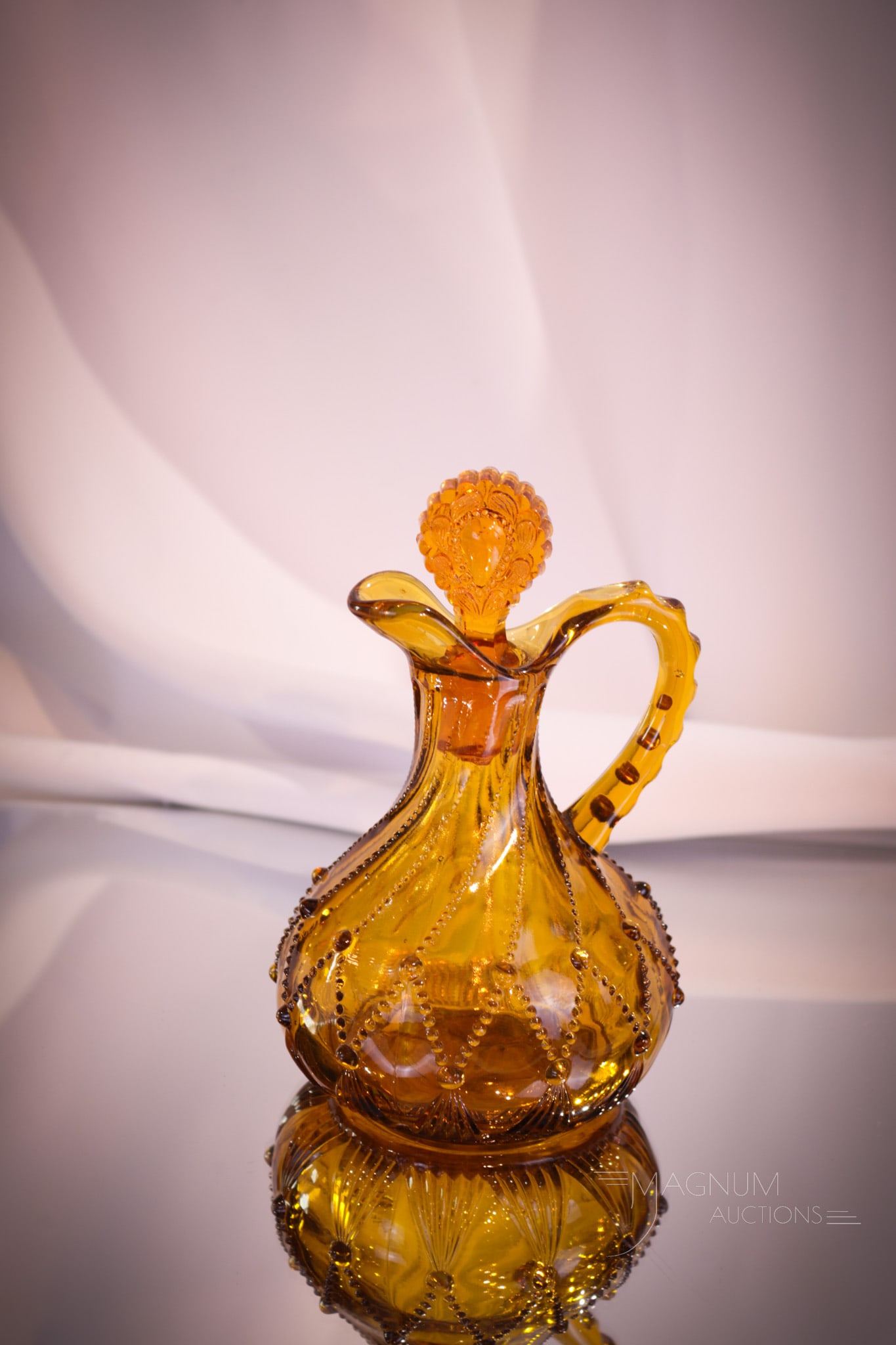 Greentown Cord Drapery Amber Glass Victorian Cruet: A great example of a Greentown Victorian glass "Cord Drapery" pattern cruet. This one with rich coloring and is complete with the original stopper. Cruet measures 5 3/4" tall.