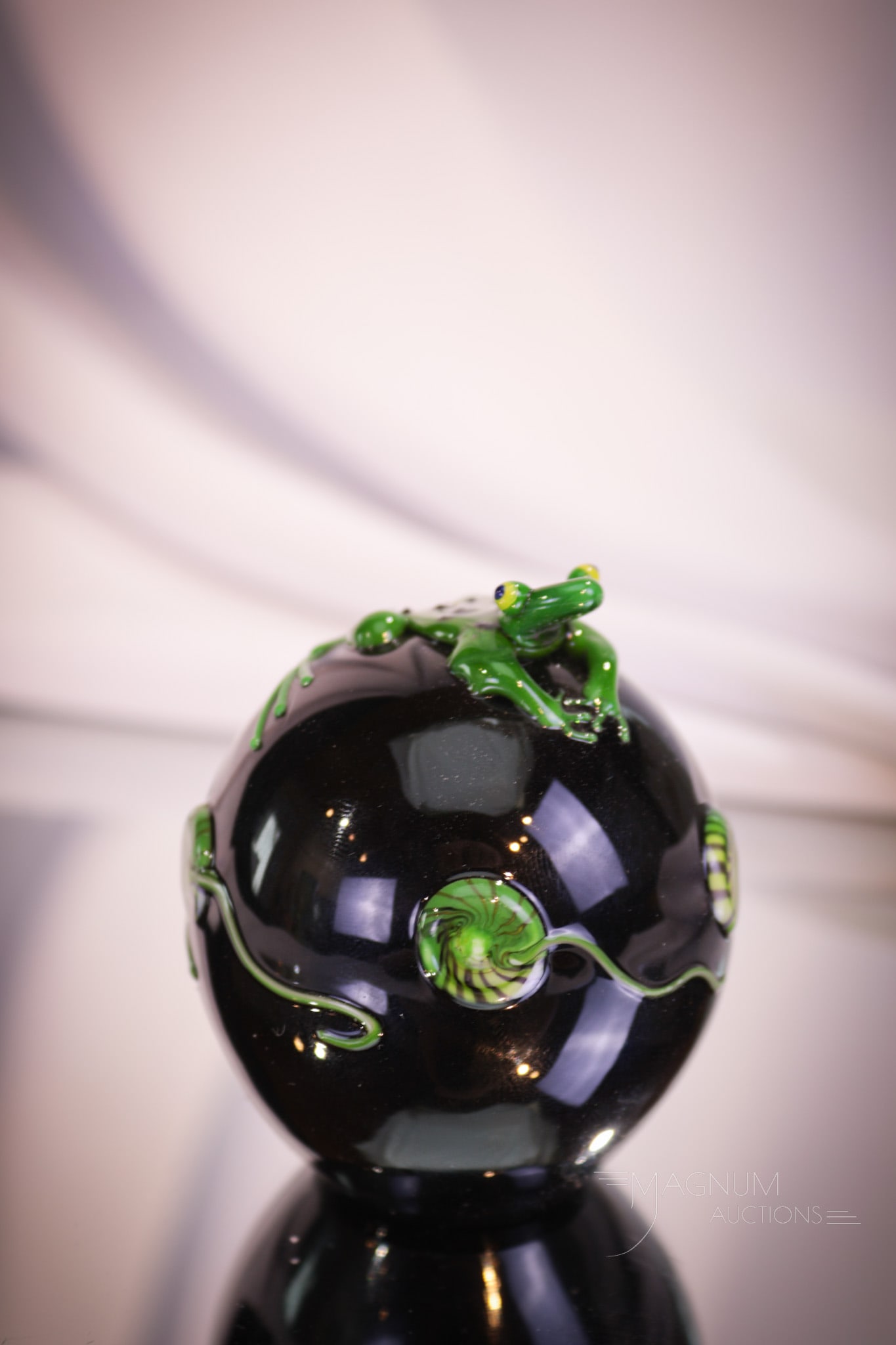 Marked Correia Frog & Lilypad Art Glass Paperweight: Charming frog and lilypad decorated black art glass paperweight marked "Correia." Piece measures 2 3/4" tall.