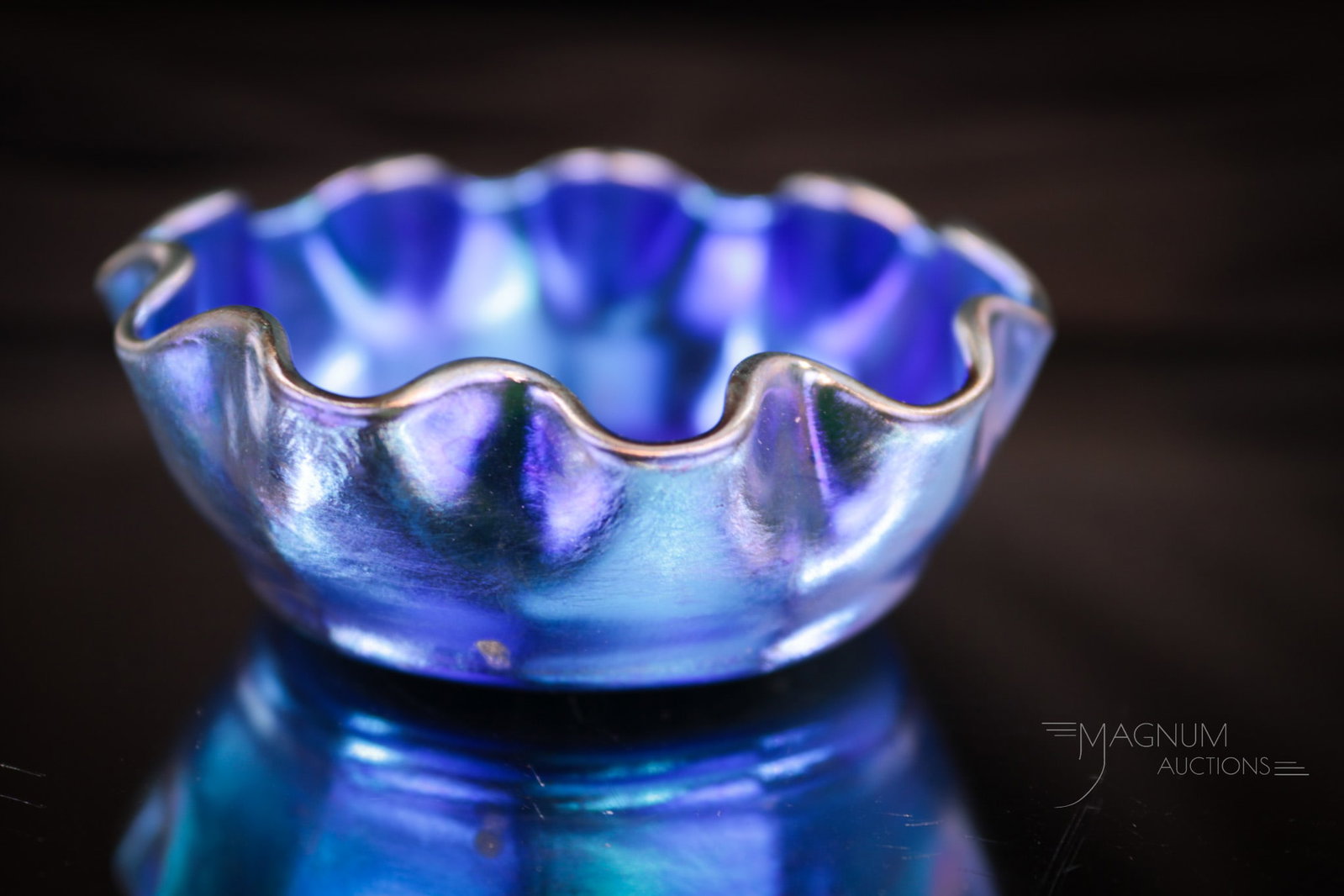 Tiffany Blue Favrile Art Glass Open Salt: Over-the-top color is found on this electric blue iridescent Tiffany Favrile art glass open salt. Piece is signed, "1256 L.C.T." Open salt measures 1" tall, 2 1/2" wide.