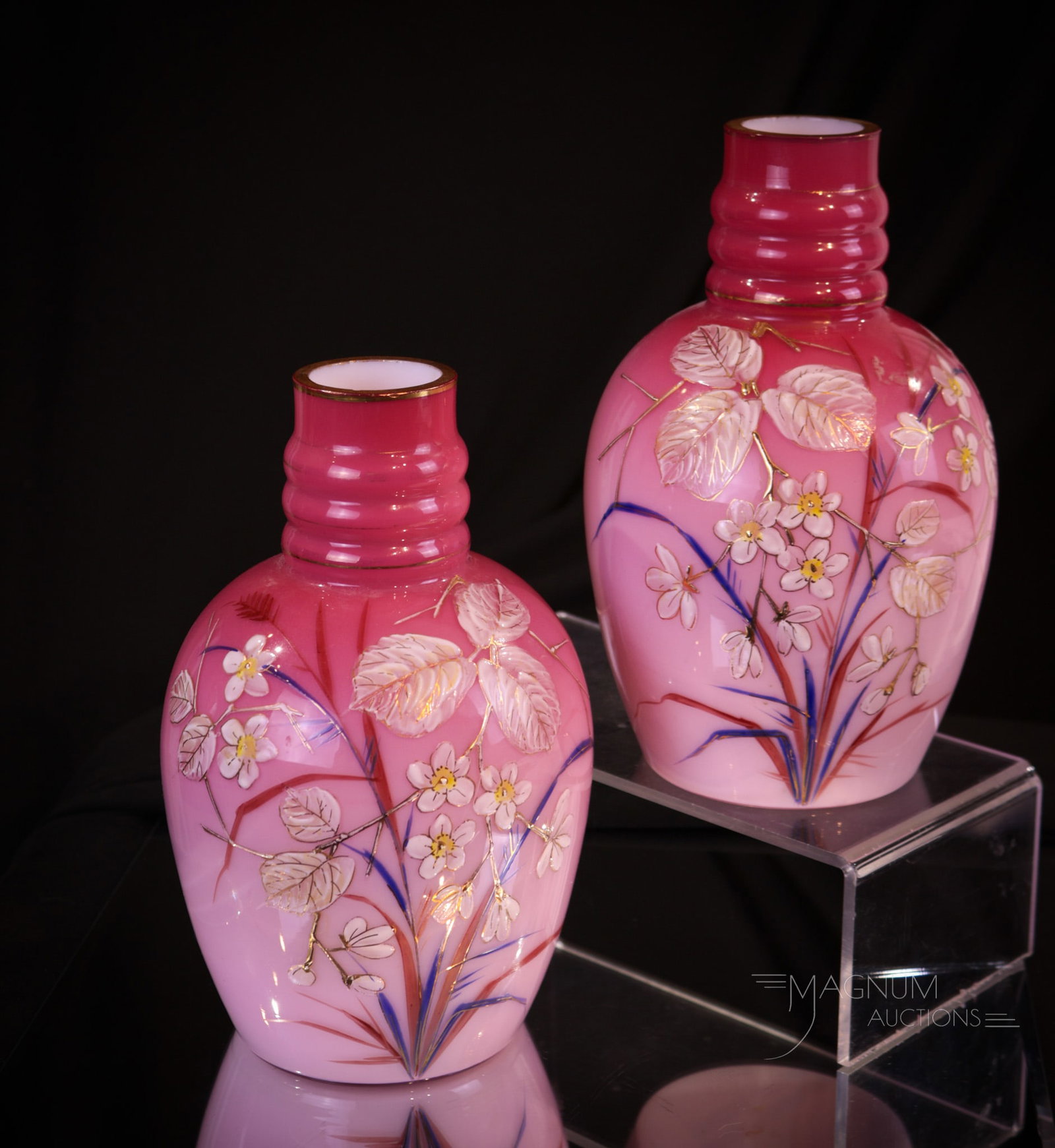 Pair of Victorian Cased Enameled Glass Mantle vases: Lovely find in this pink-cased enameled glass mantle vase pair. Each of these attractive vases is decorated with florals. Great eye-pleasing form to each vase. The pair measures 8" tall.
