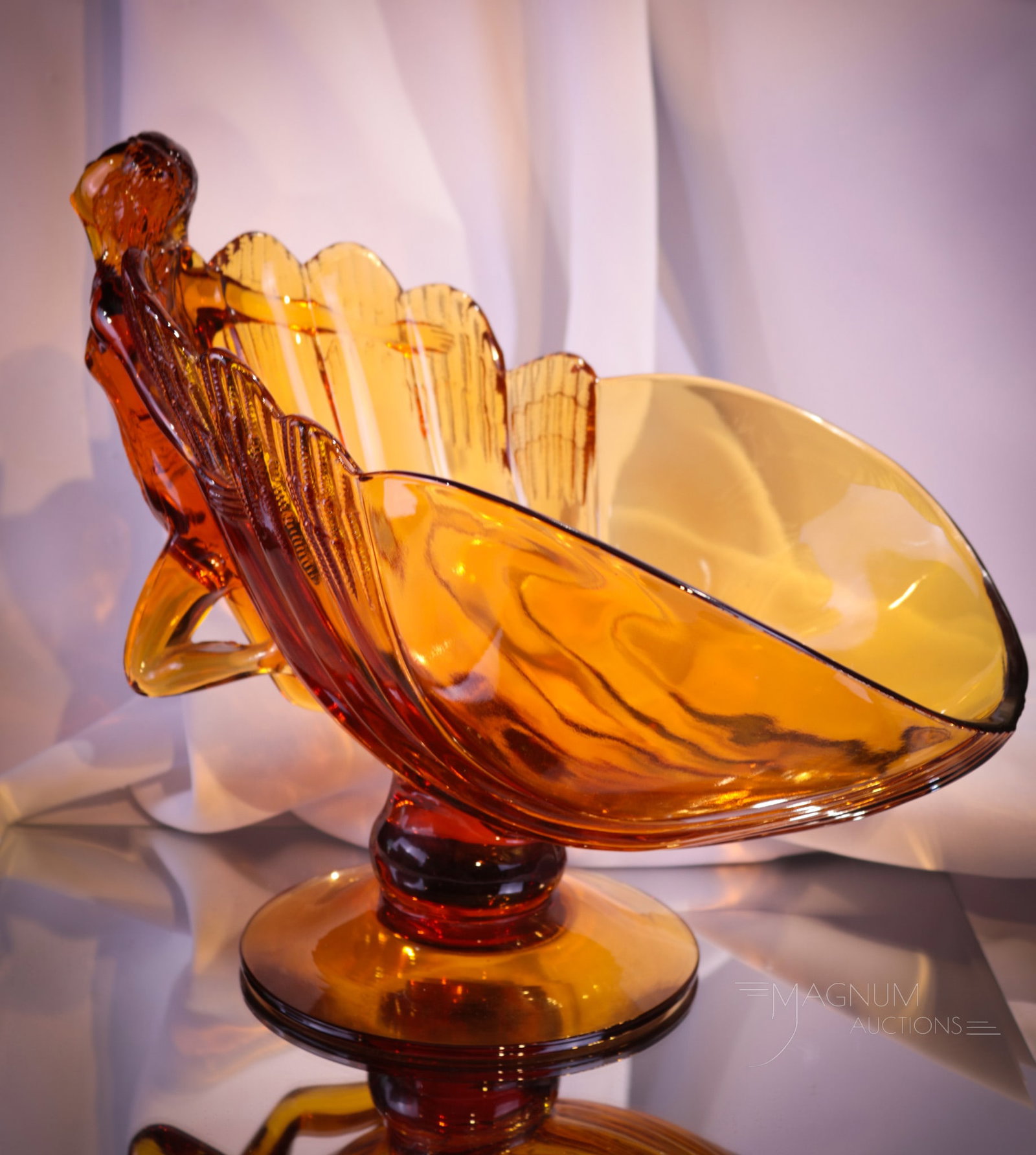 Cambridge Glass Amber Nude Flying Lady Bowl: Beautiful and rare amber Cambridge glass Flying Nude glass bowl. This bowl measures 9" tall, 11" long. It's Mother Magnum approved for size. Will you be the lucky new owner?