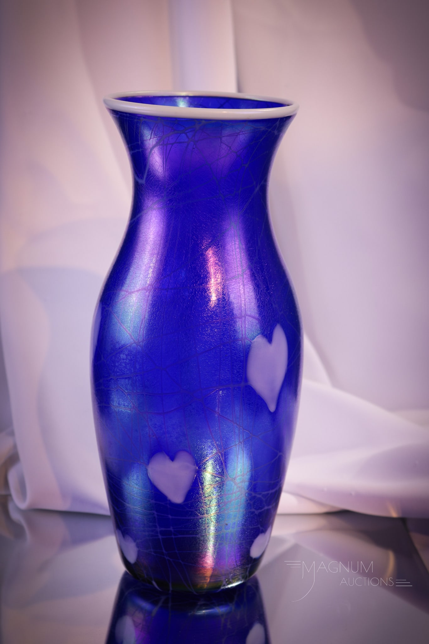 Imperial Cobalt Iridescent Heart & Vine Vase: Gorgeous cobalt iridescent Heart & Vine decorated vase complete with white rim. Vase measures 11" tall.