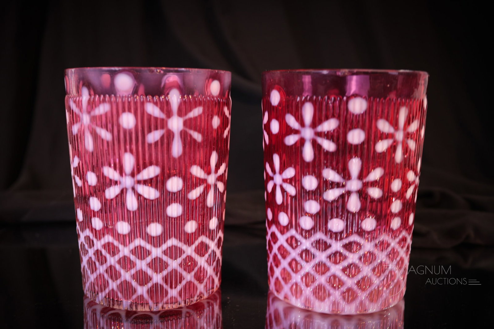 2 pc Lot Northwood Ribbed Christmas Snowflake Cranberry Opalescent Tumblers: Two wonderful examples of cranberry Northwood opalescent "Christmas Snowflake" pattern tumblers. Each tumbler has super color and opal. Each measures 3 3/4" tall. Provenance: From the estate of the la