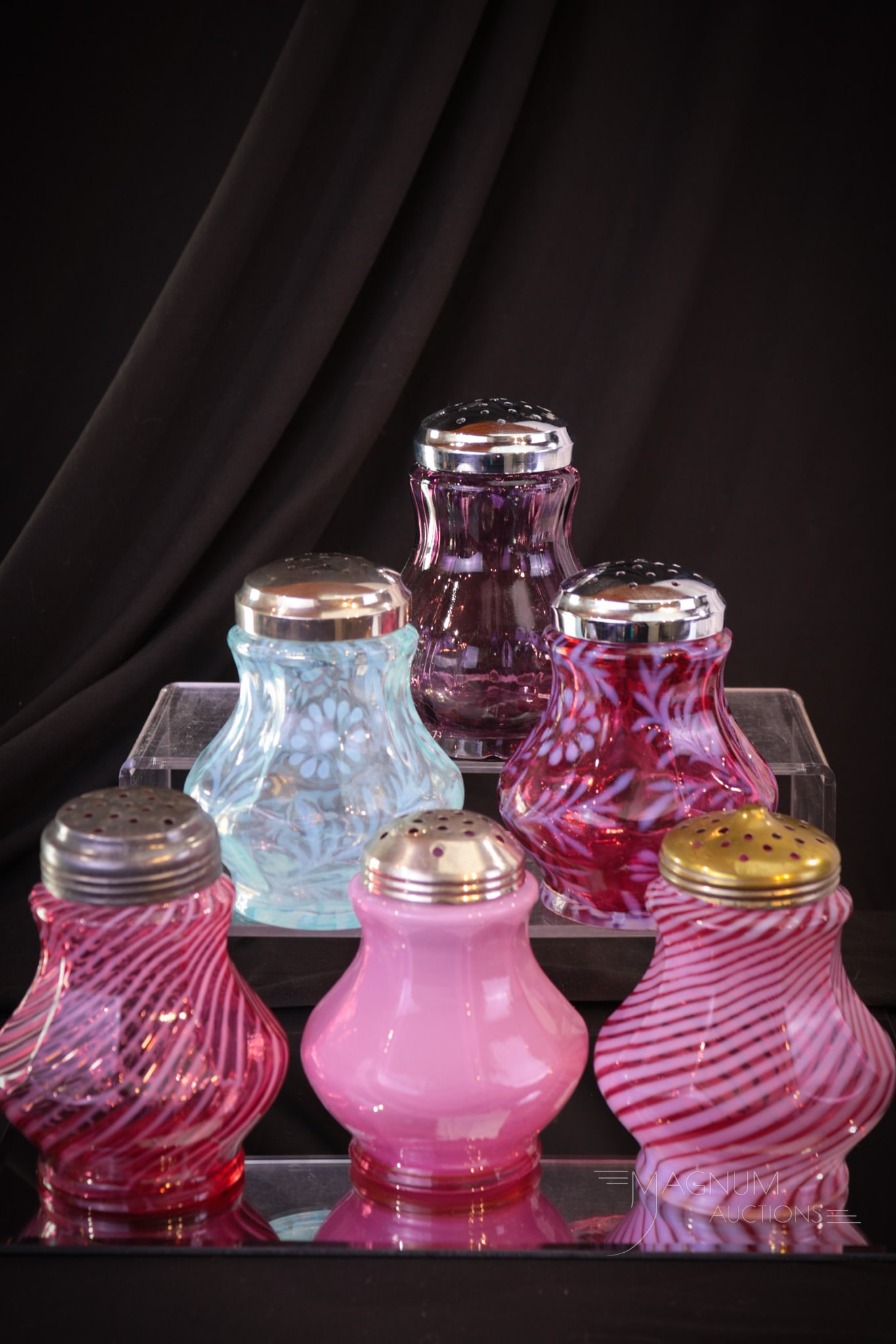 6 pc Lot Fenton Glass Sugar Shakers Muffineers: An assortment of Fenton glass sugar shaker or muffineers. This lot includes cranberry and blue opalescent Daisy & Fern, Spiral and so much more. Tallest measures