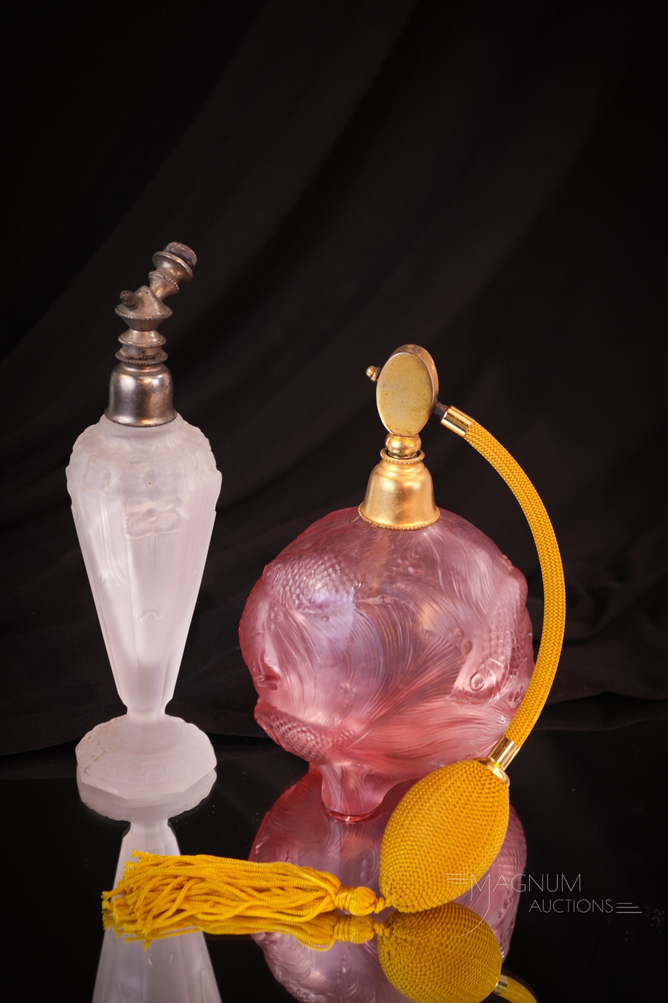 2 pc Lot Satin Glass Perfume Atomizers Joseph Scmidt & Ingrid: Two selections sure to be collection enhancing. This lot includes a Czech Joseph Scmidt in clear frosted glass (lacking bulb), along with an Ingrid "Venus Rising" pink frosted example, circa 1937. Tal