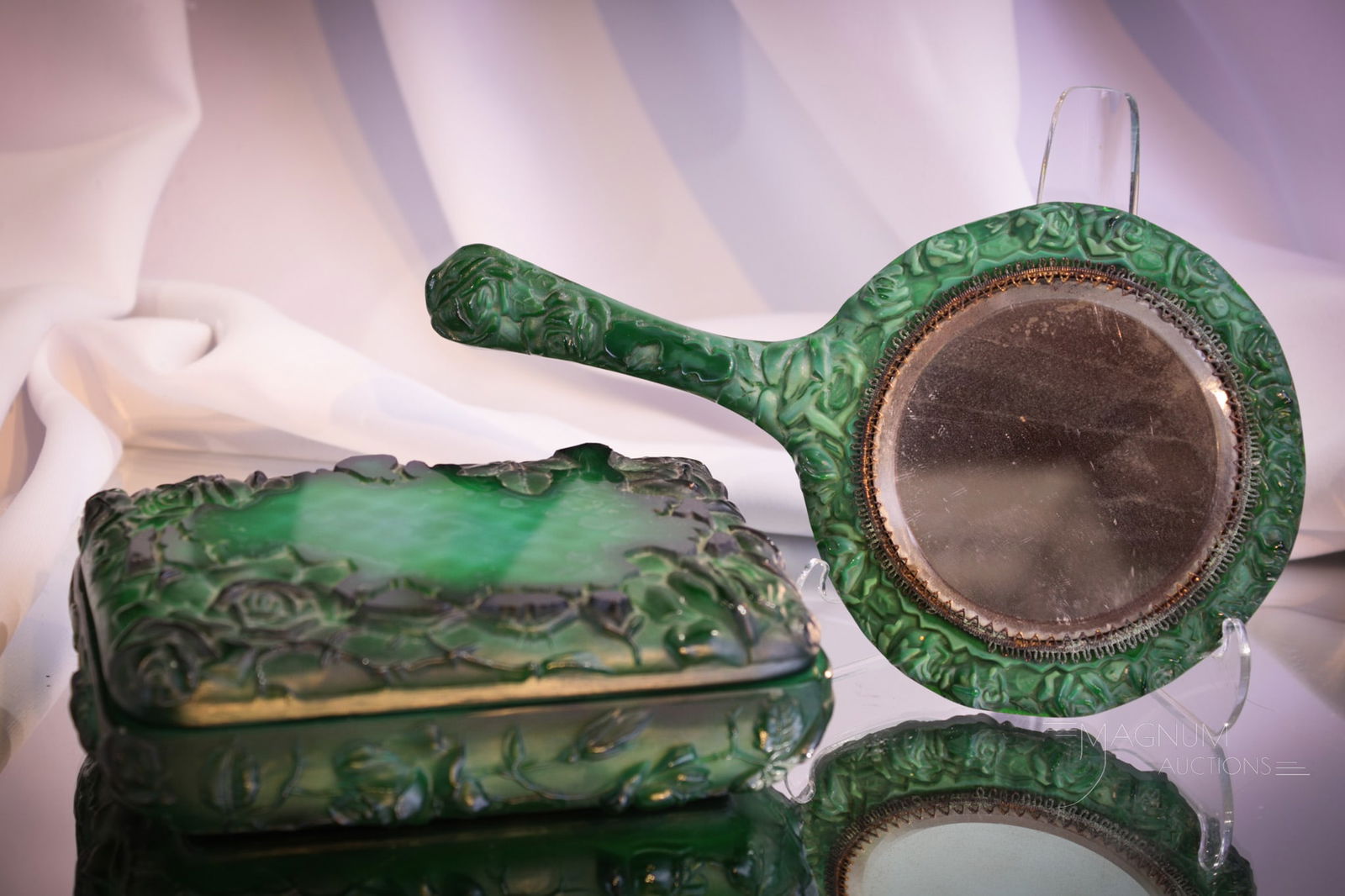 2 pc Lot Czechoslovakian Glass Malachite Dresser Vanity Mirror & Box: Select offering of two fine Czech glass malachite dresser vanity articles. This lot is comprised of a hand mirror along with a covered box. Box has a floral motif while the hand mirror features a fema
