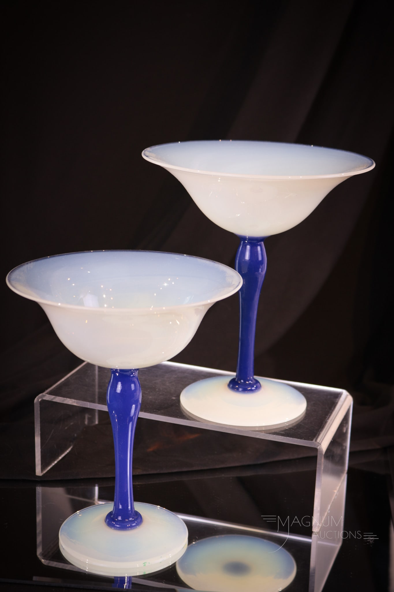 Pair of Fry Foval Blue Stemmed Compotes: Select offering of a pair of Fry Foval compotes. Each has a blue stem. Both measure 7" tall.