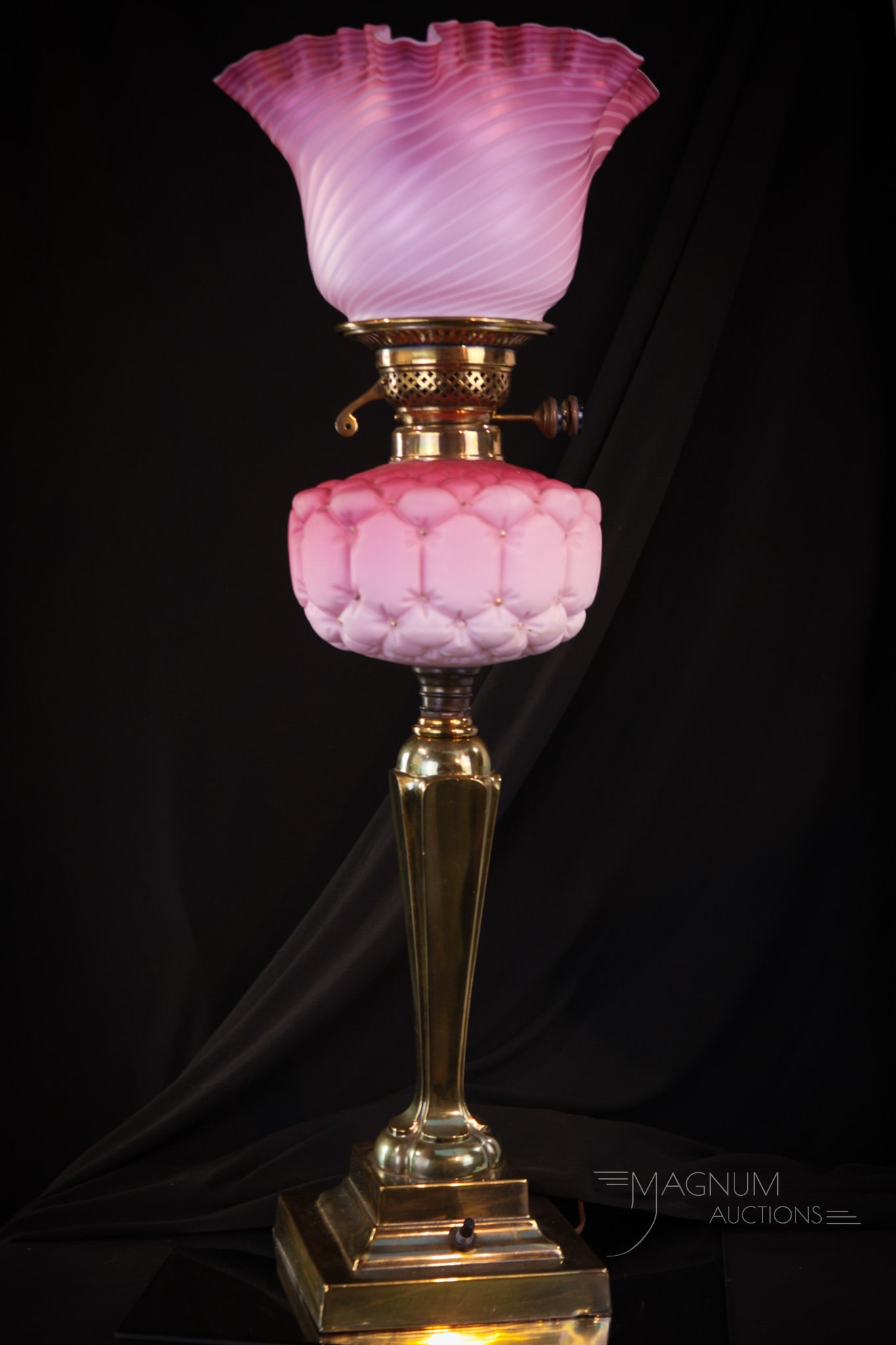 Victorian English Banquet Oil Lamp Mother of Pearl Glass: Pretty in pink Victorian English cased glass banquet lamp. Lamp is complete with a mother of pearl satin Swirl pattern shade. Lamp has been electrified. Lamp measures 25" tall. Bruise to side of shade